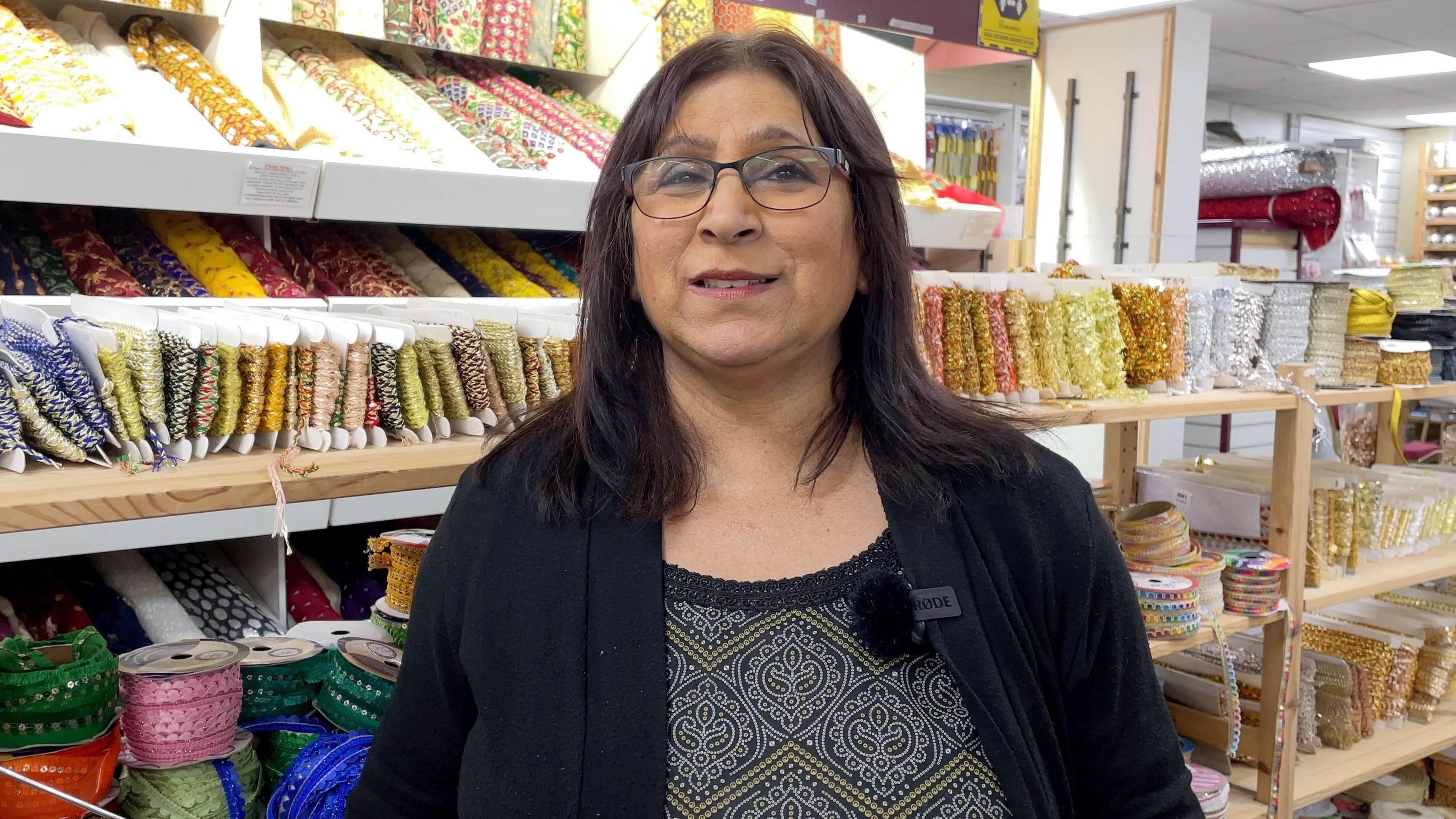 Sabra Kader standing in Bombay Stores, as it is today, continuing the legacy her parents built.
