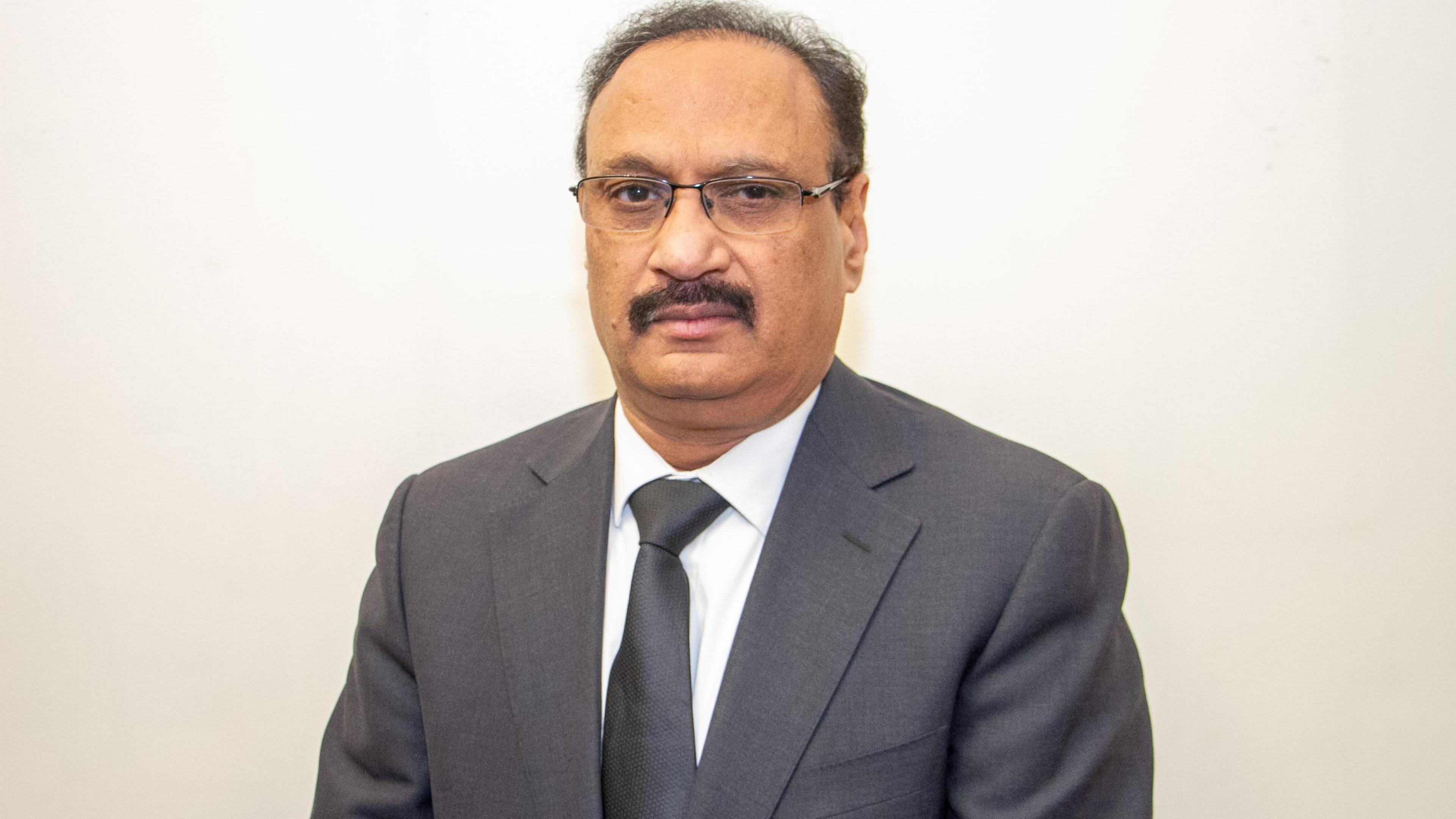 Man in grey blazer and tie 