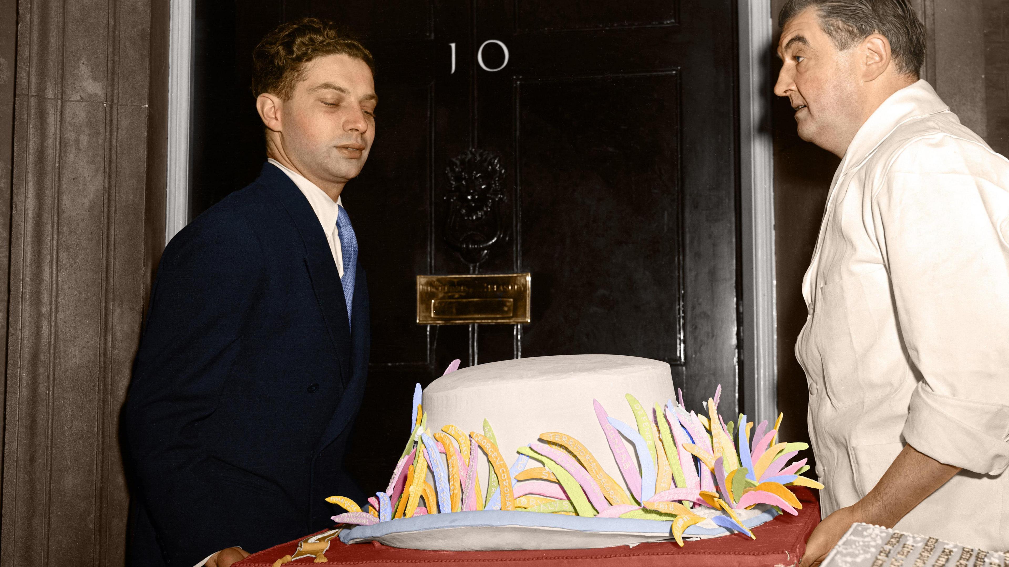 A cake being delivered to 10 Downing Street by two men