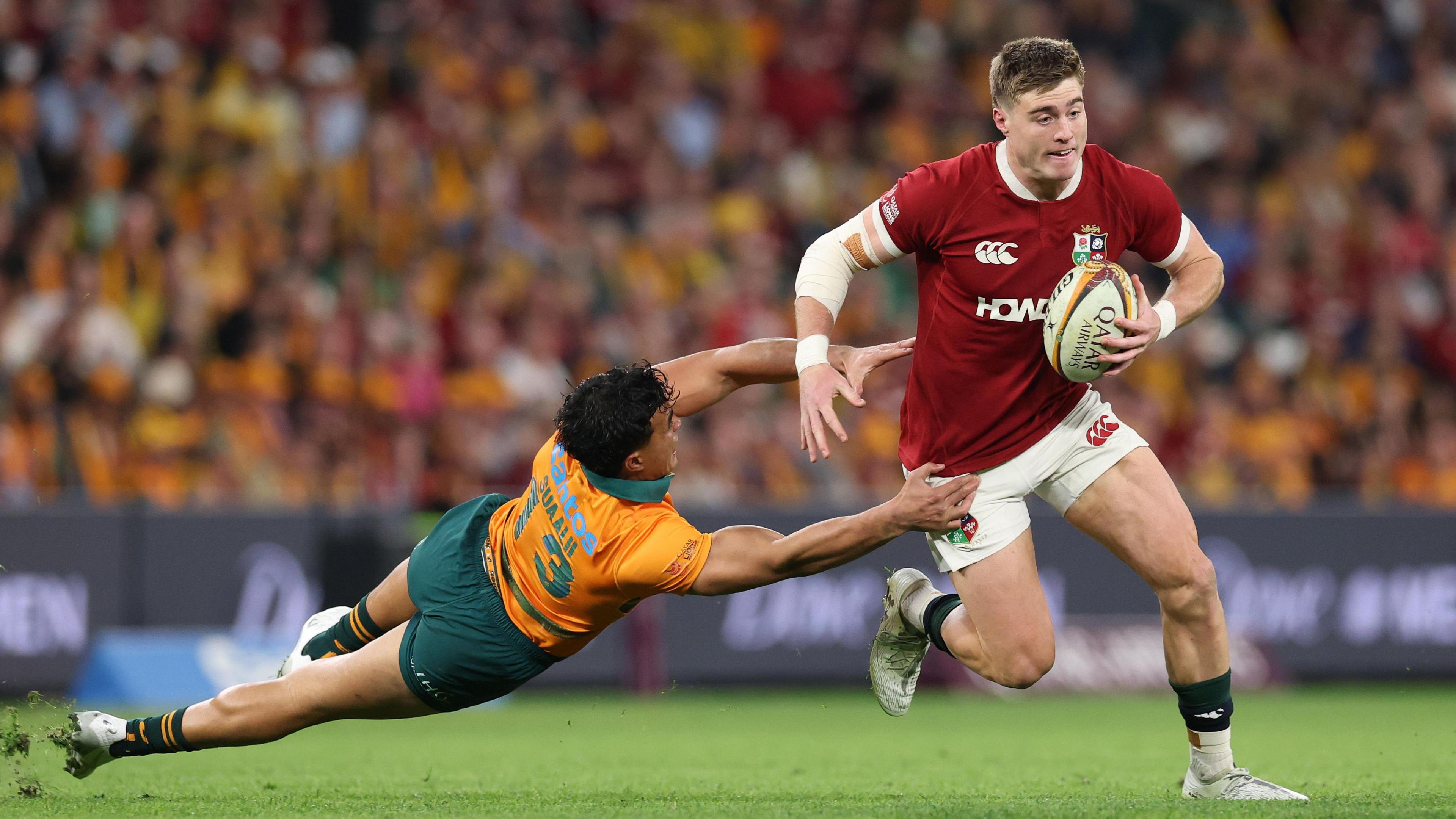 British and Irish Lions' Tommy Freeman evades Australia's Joseph Suaalii