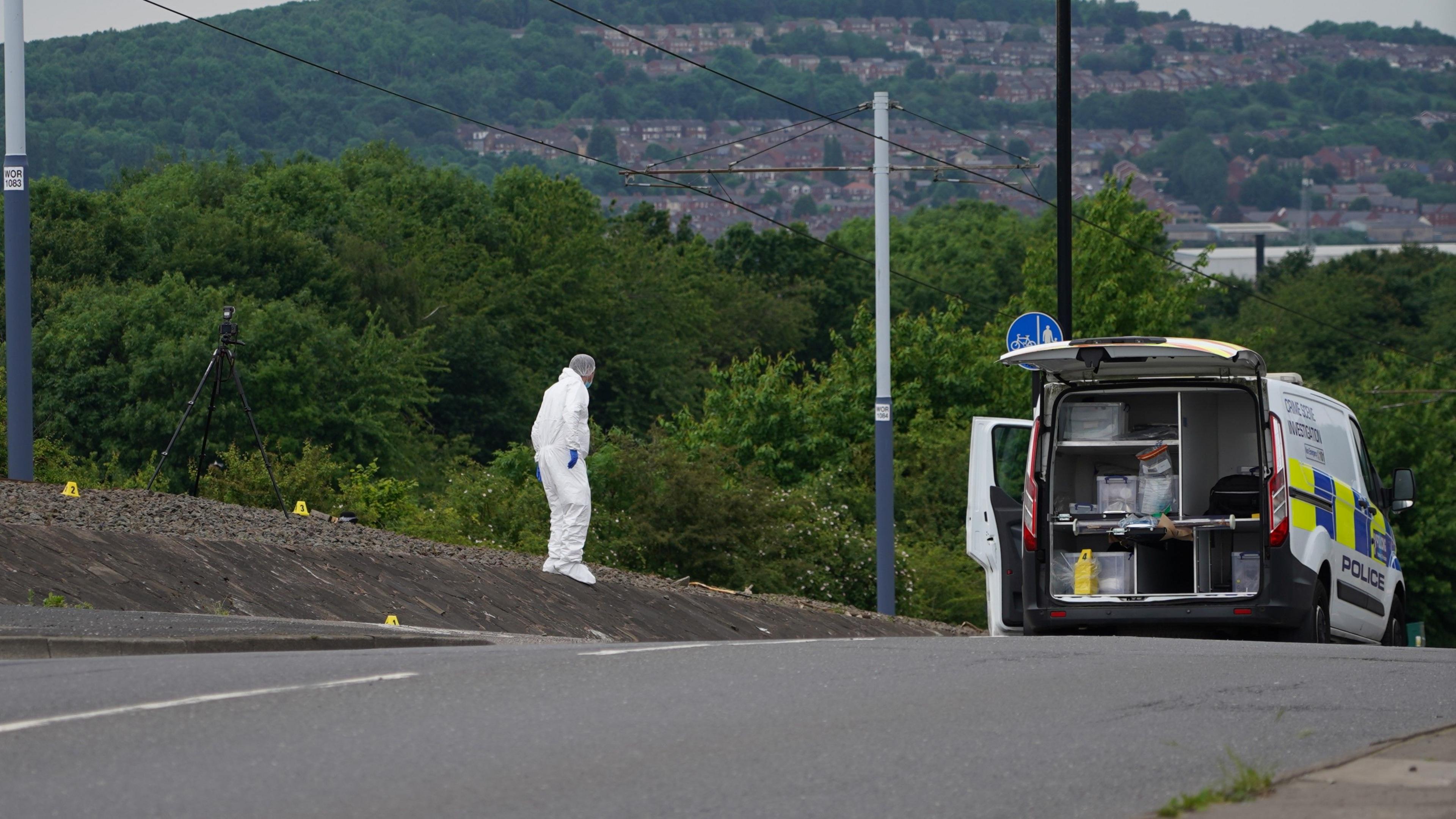 A crime scene detective wearing white