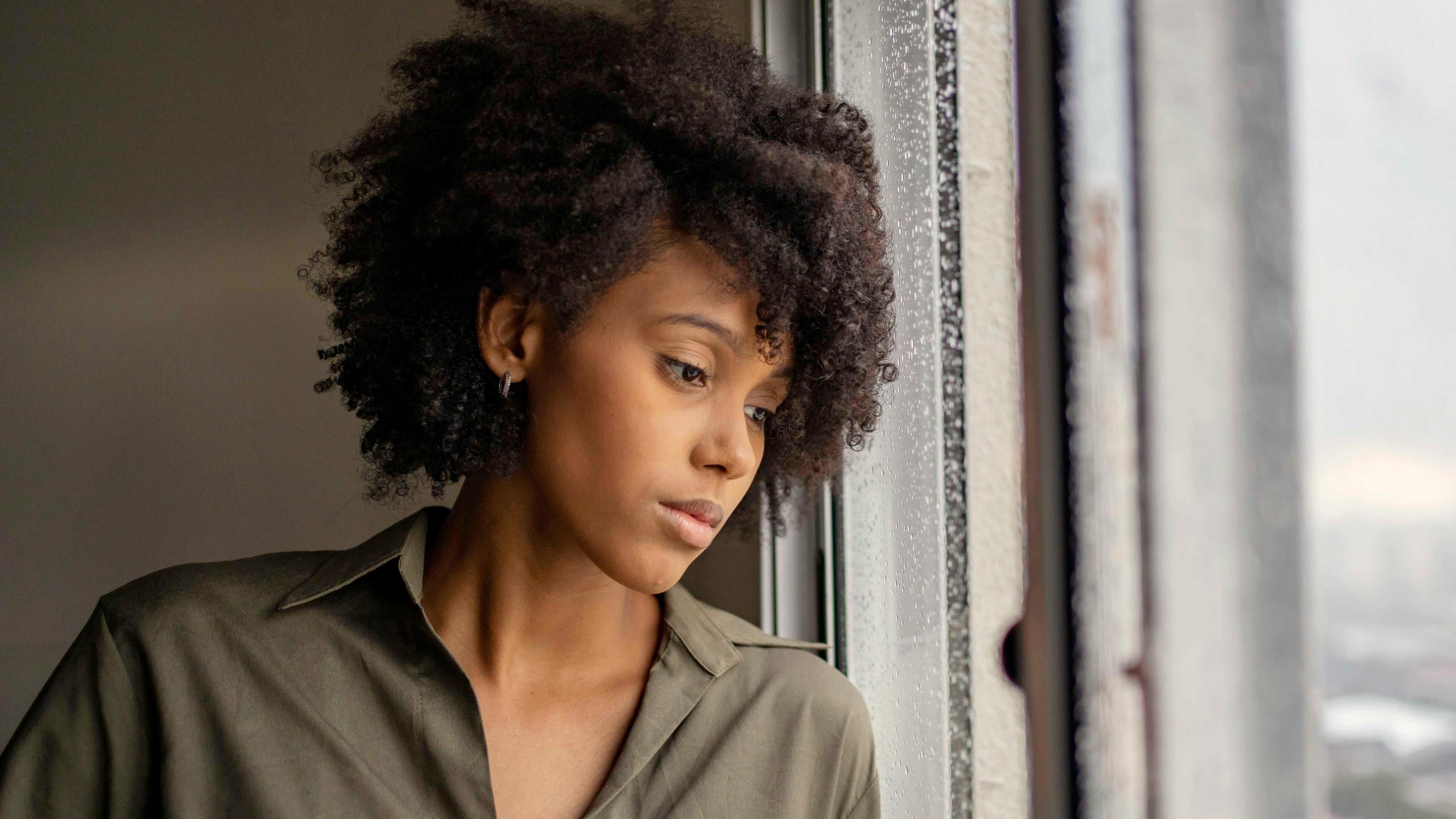 A woman looking out of a window. 