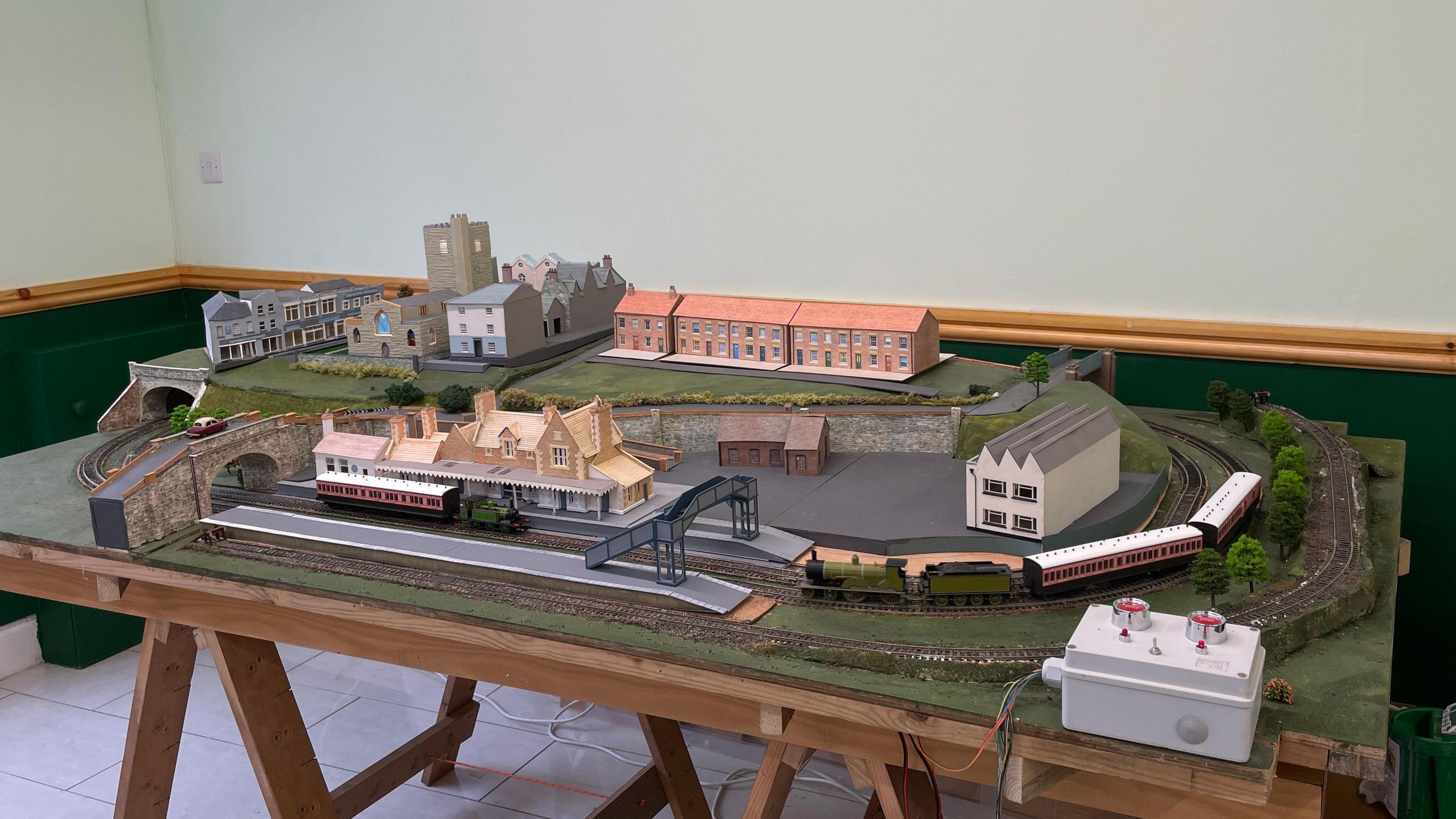 A model version of Axminster train station with the town in the background. 