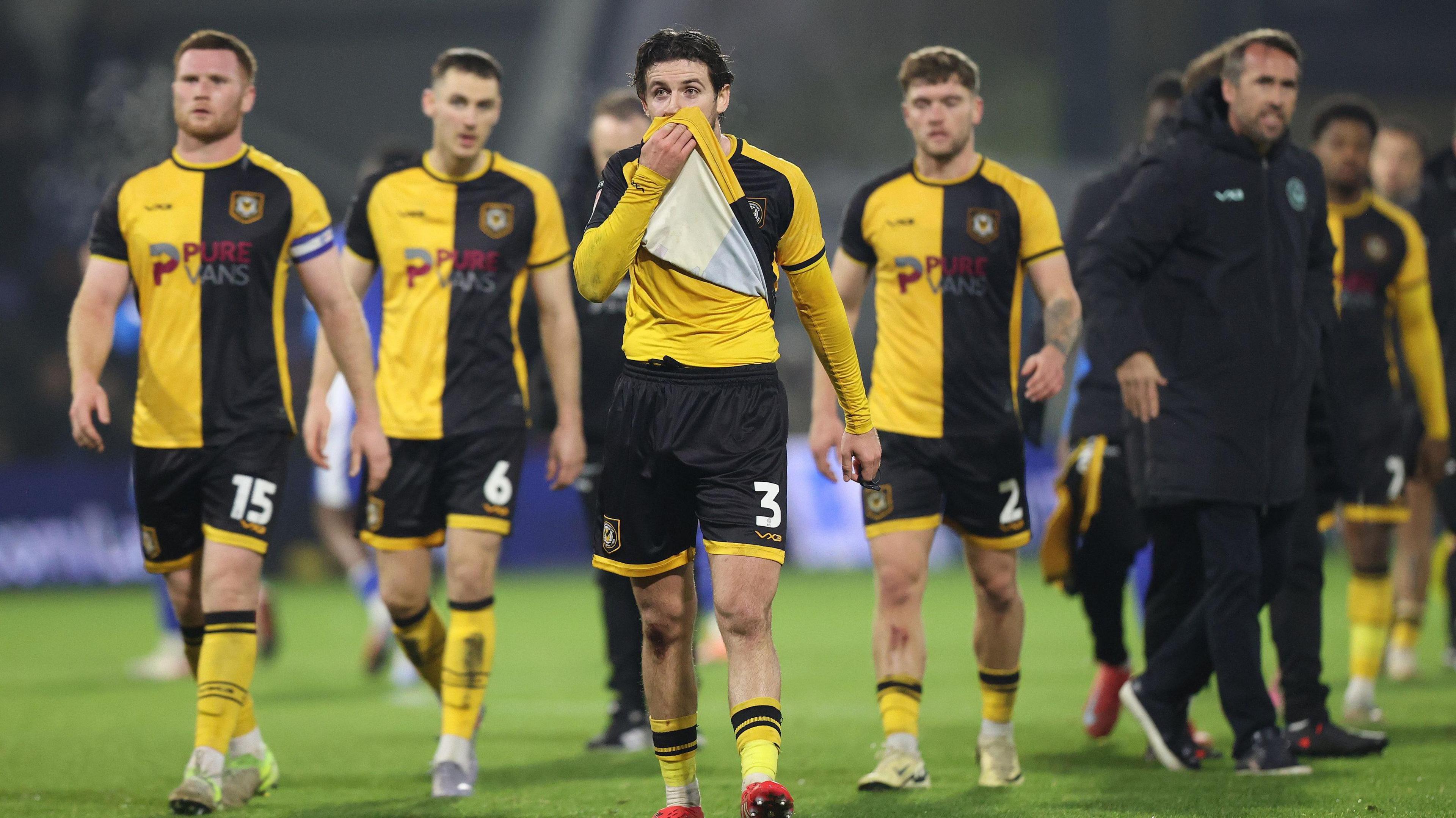 Newport players look dejected after full-time against Oldham Athletic at Boundary Park