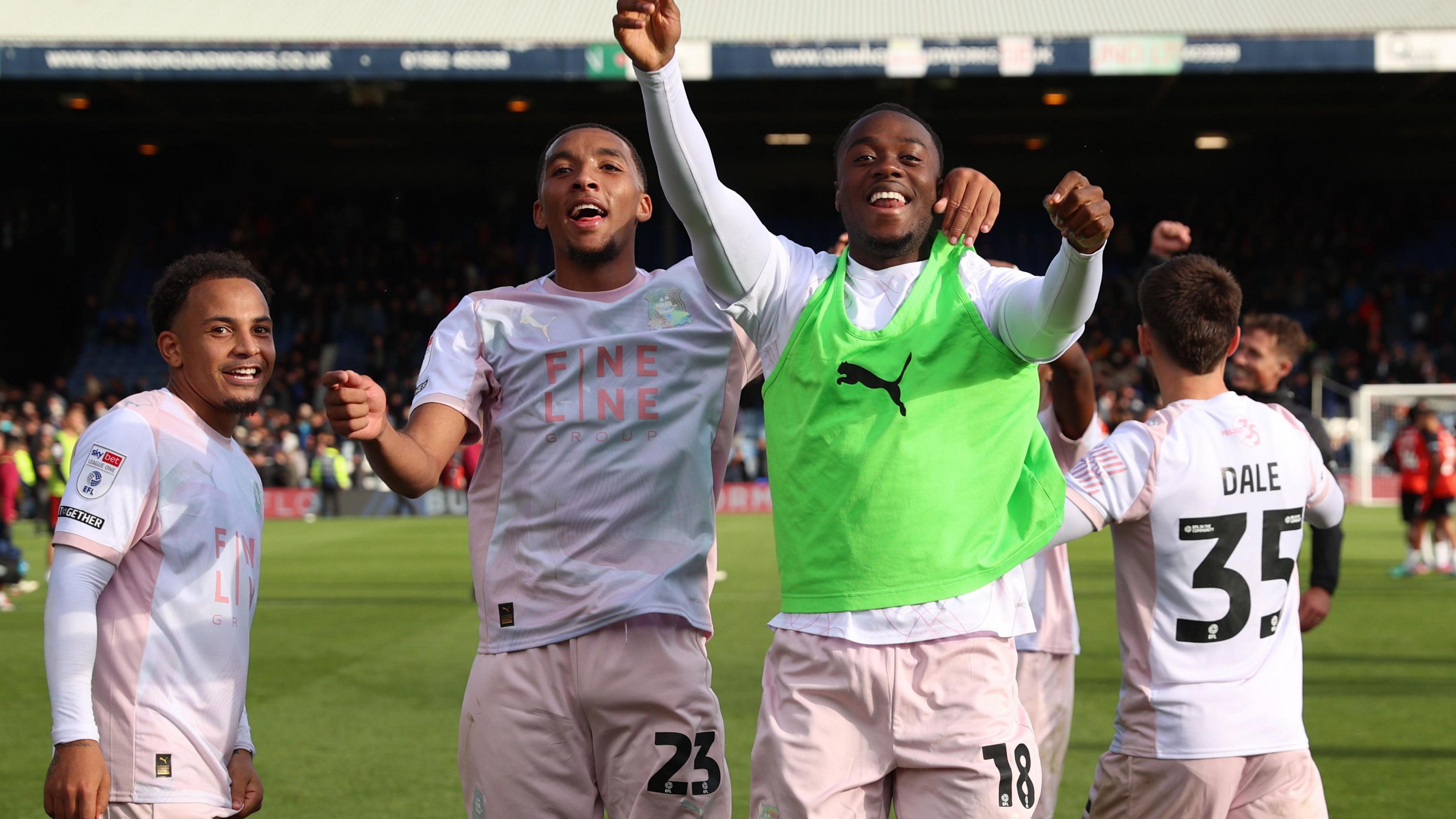 Plymouth Argyle players celebrate winning at Luton Town