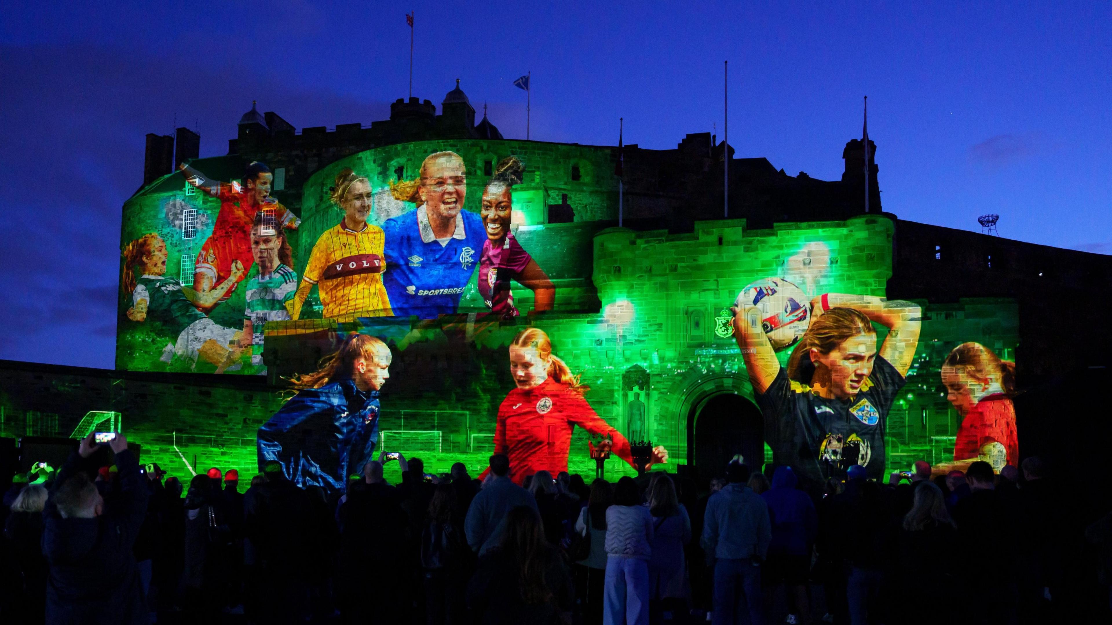 General view of a projection onto Edinburgh Castle with footage of professional players as young trainees