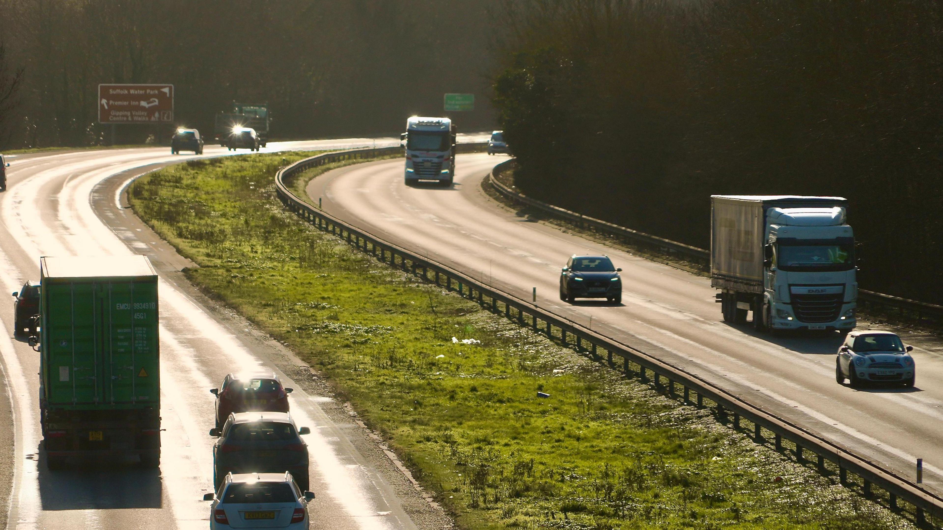 A general view of the A14 carriageway close to Ipswich on a sunny day. The photo has been taken from a bridge above the carriageway. Vehicles can be seen travelling along each side of the road.