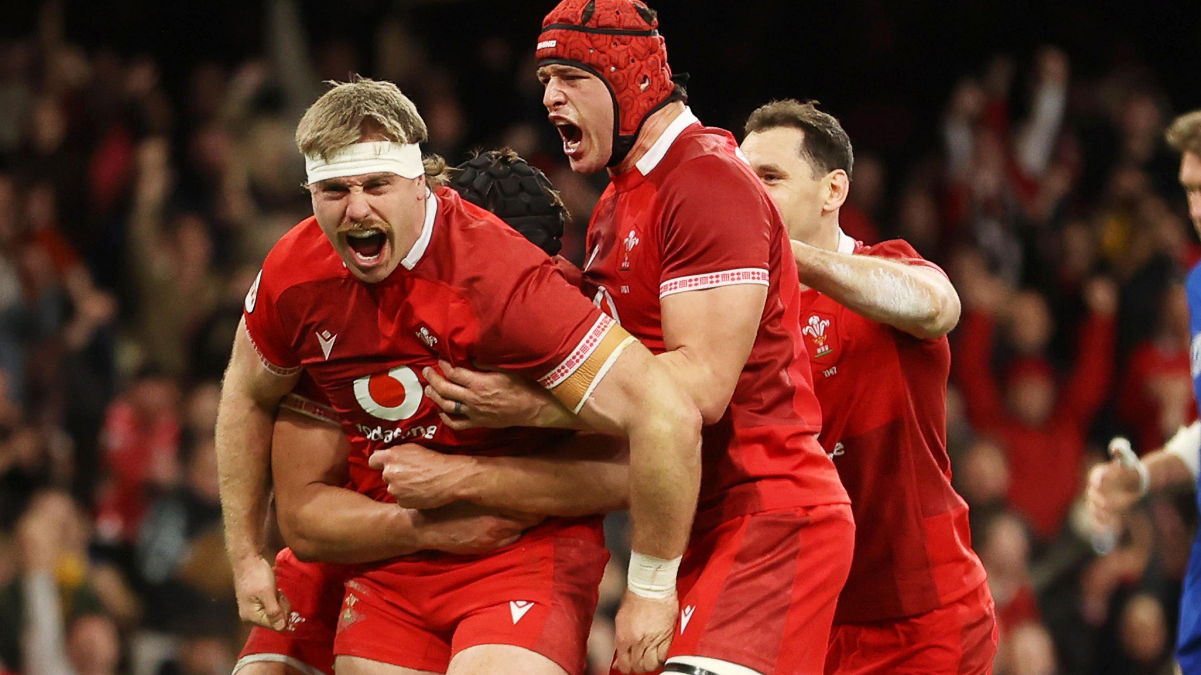 Aaron Wainwright celebrates scoring for Wales against Italy