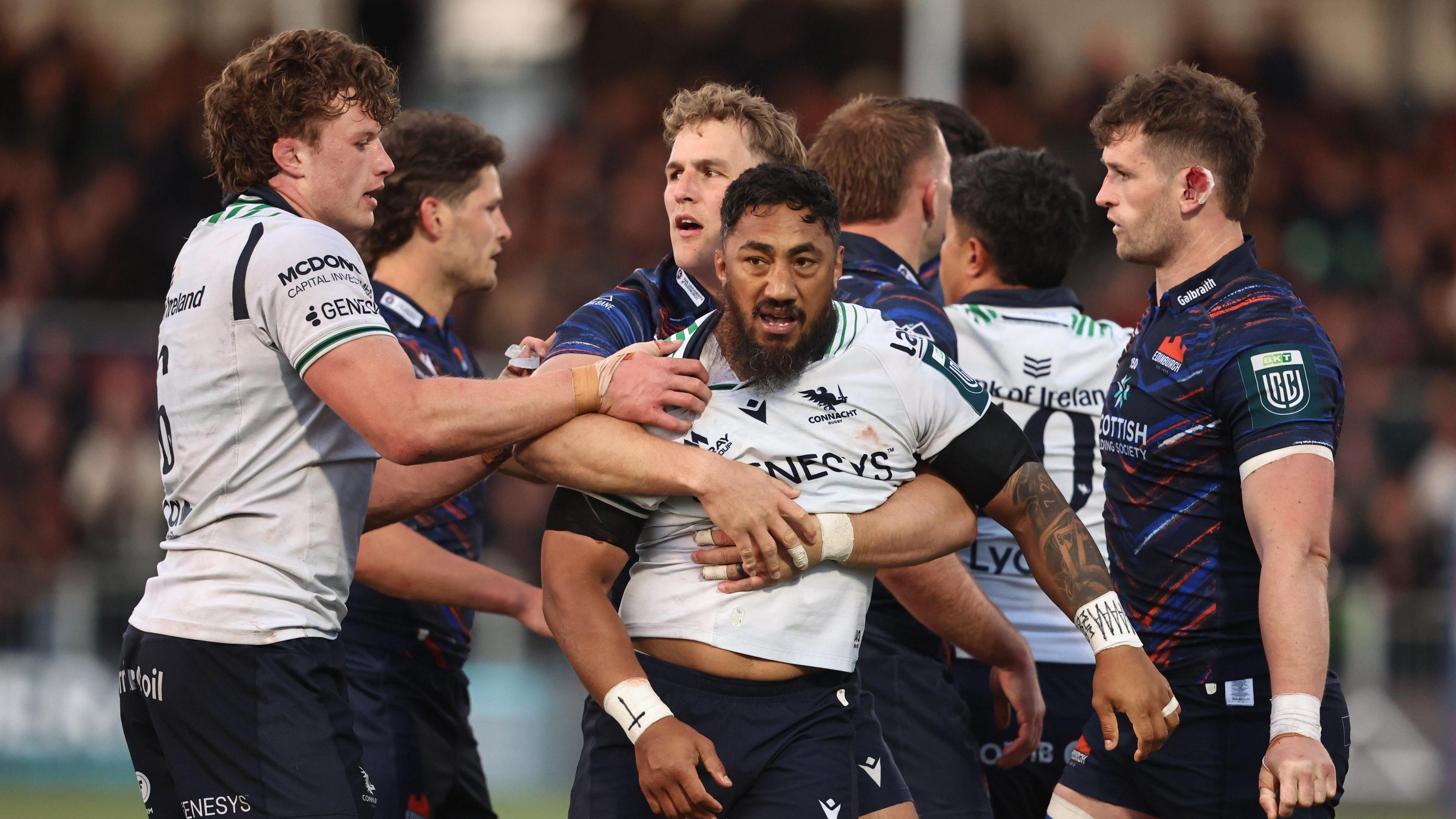 Bundee Aki is held by Duhan van der Merwe