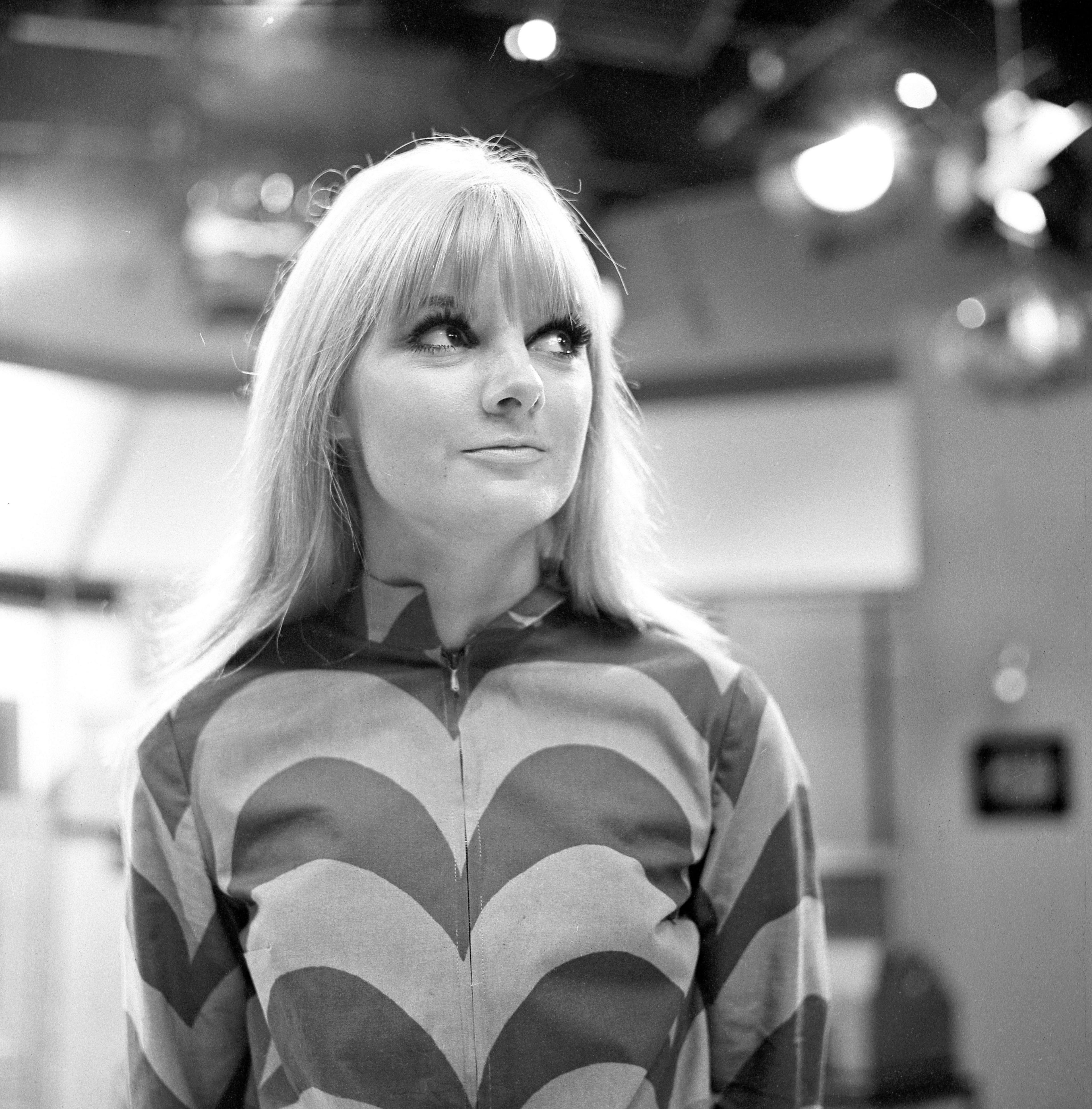 Black and white photo of Anneke Wills in a chevron patterned dress