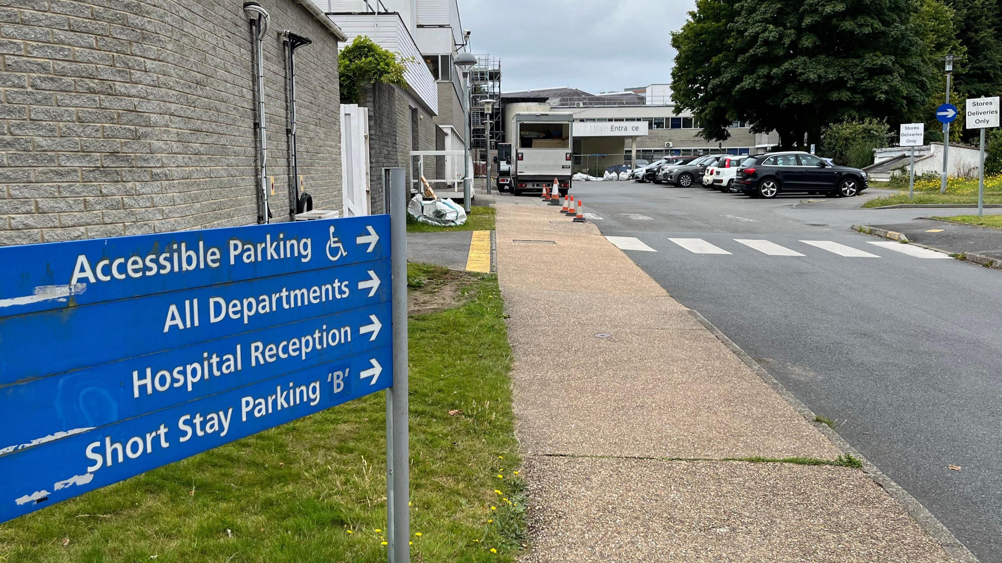 A sign outside of Guernsey's Princess Elizabeth Hospital pointing to accessible parking and the rest of the hospital.