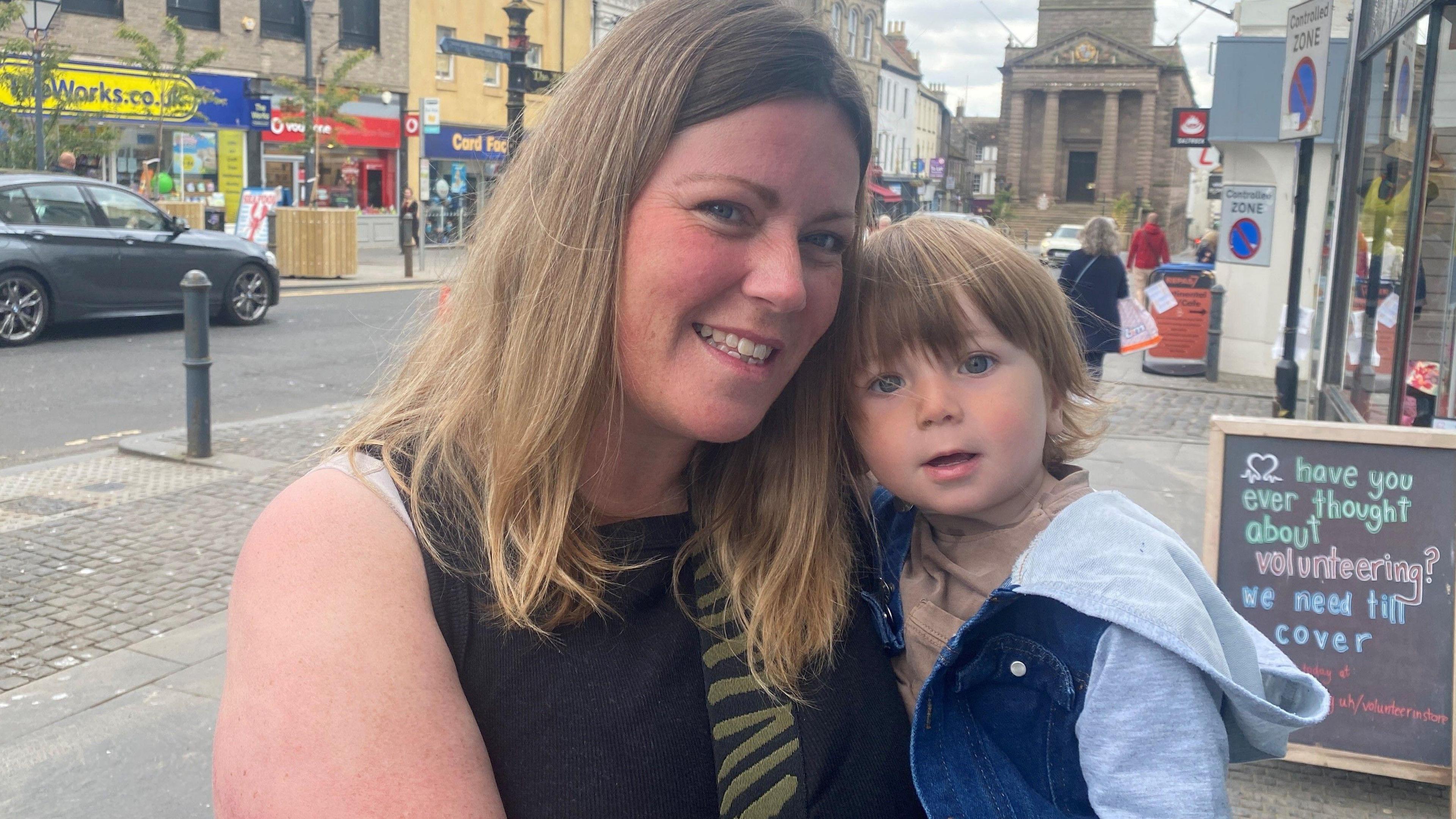 Cheryl Gill standing on Berwick high street with her son