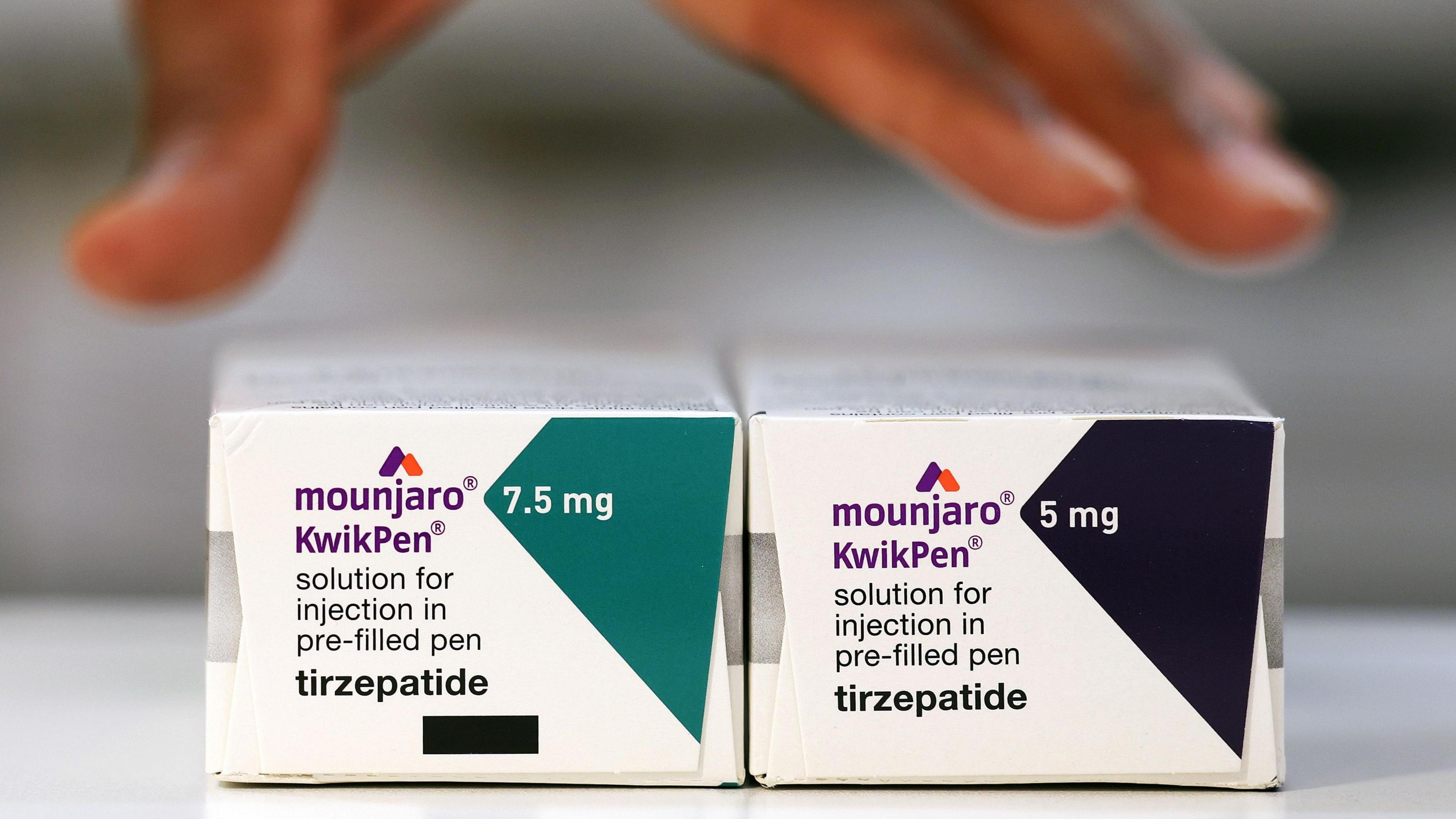 A close up of two boxes of the drug Mounjaro with different doses. 