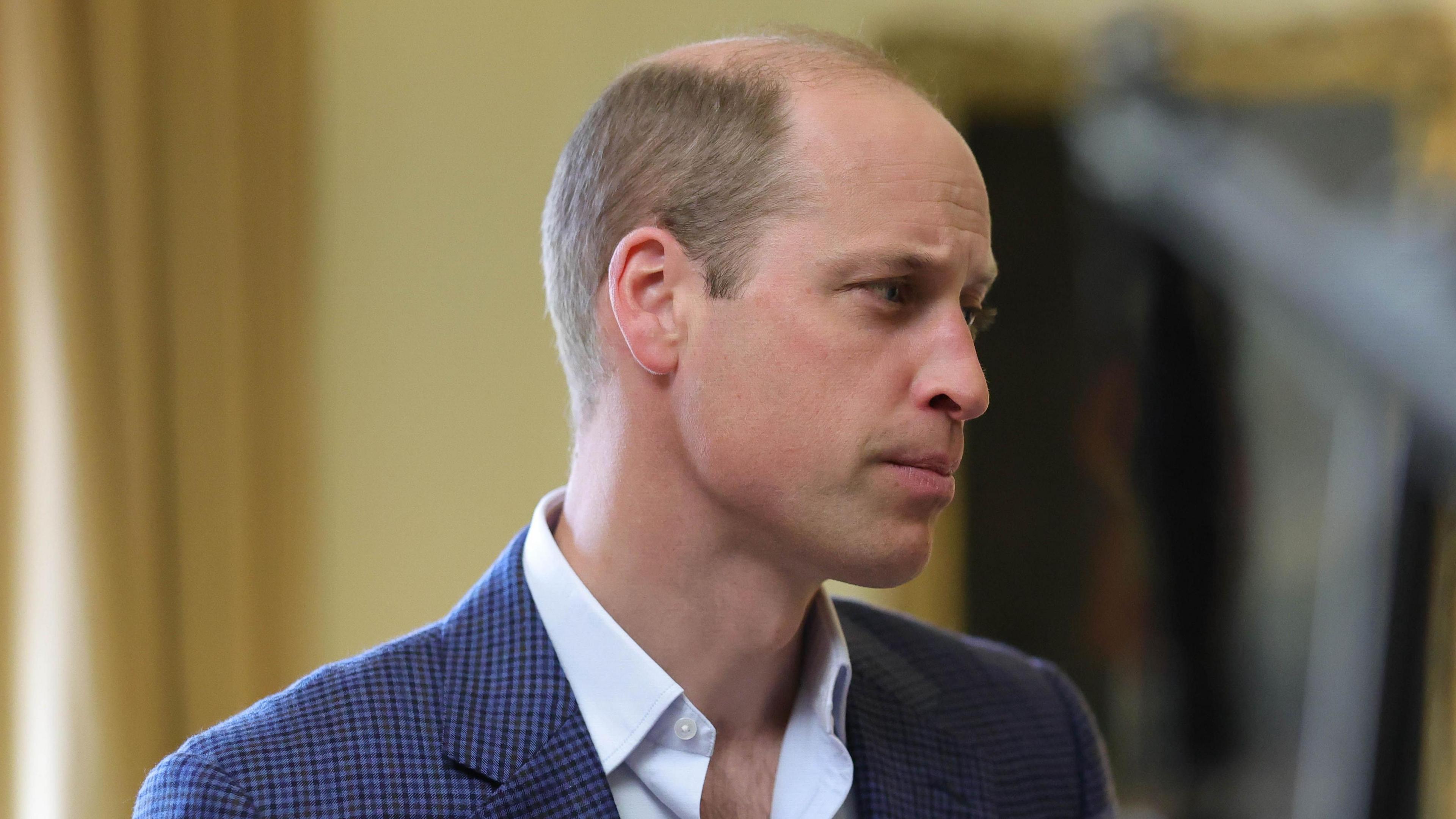 A head-and-shoulders image of Prince William, in a blazer and white shirt, during an interview about homelessness