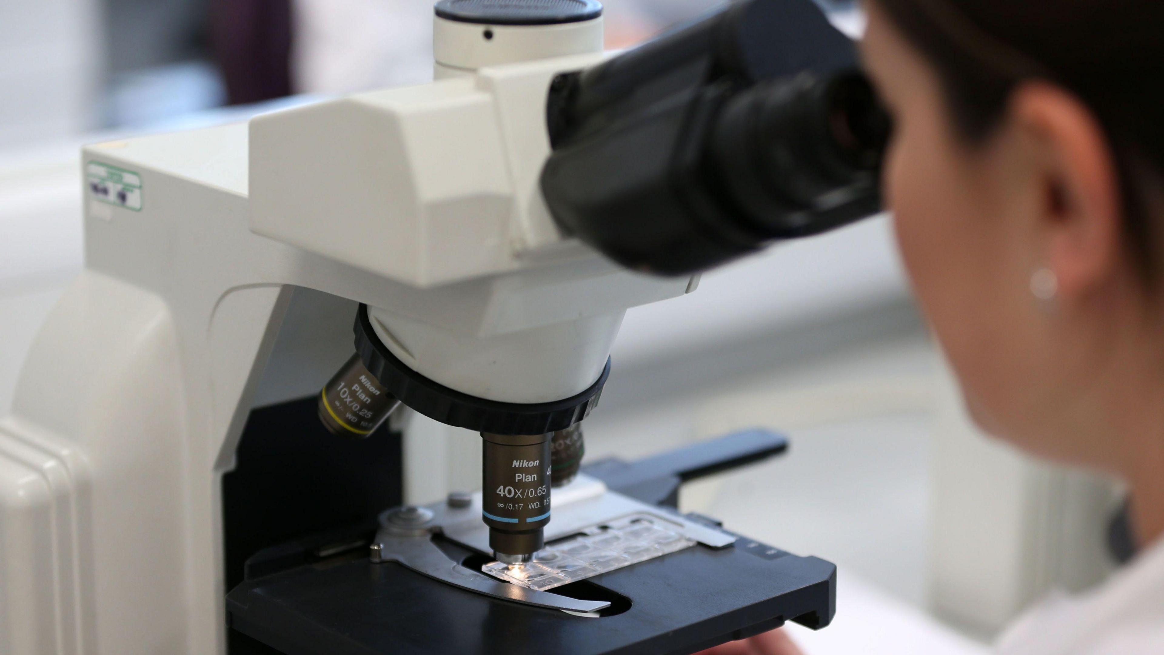 a general View of a woman using a microscope