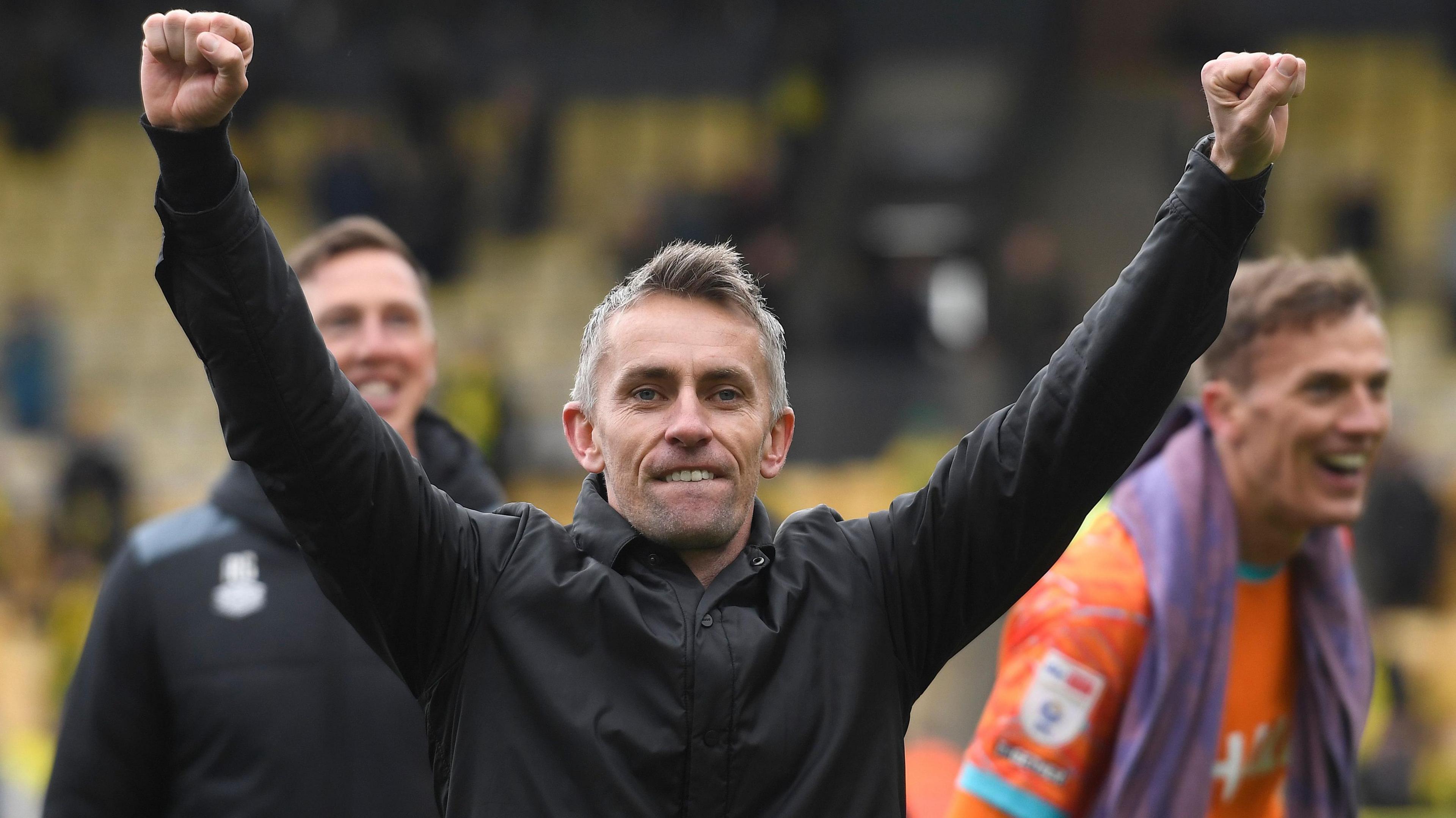 Kieran McKenna holds his arms aloft after Ipswich's victory at Norwich 