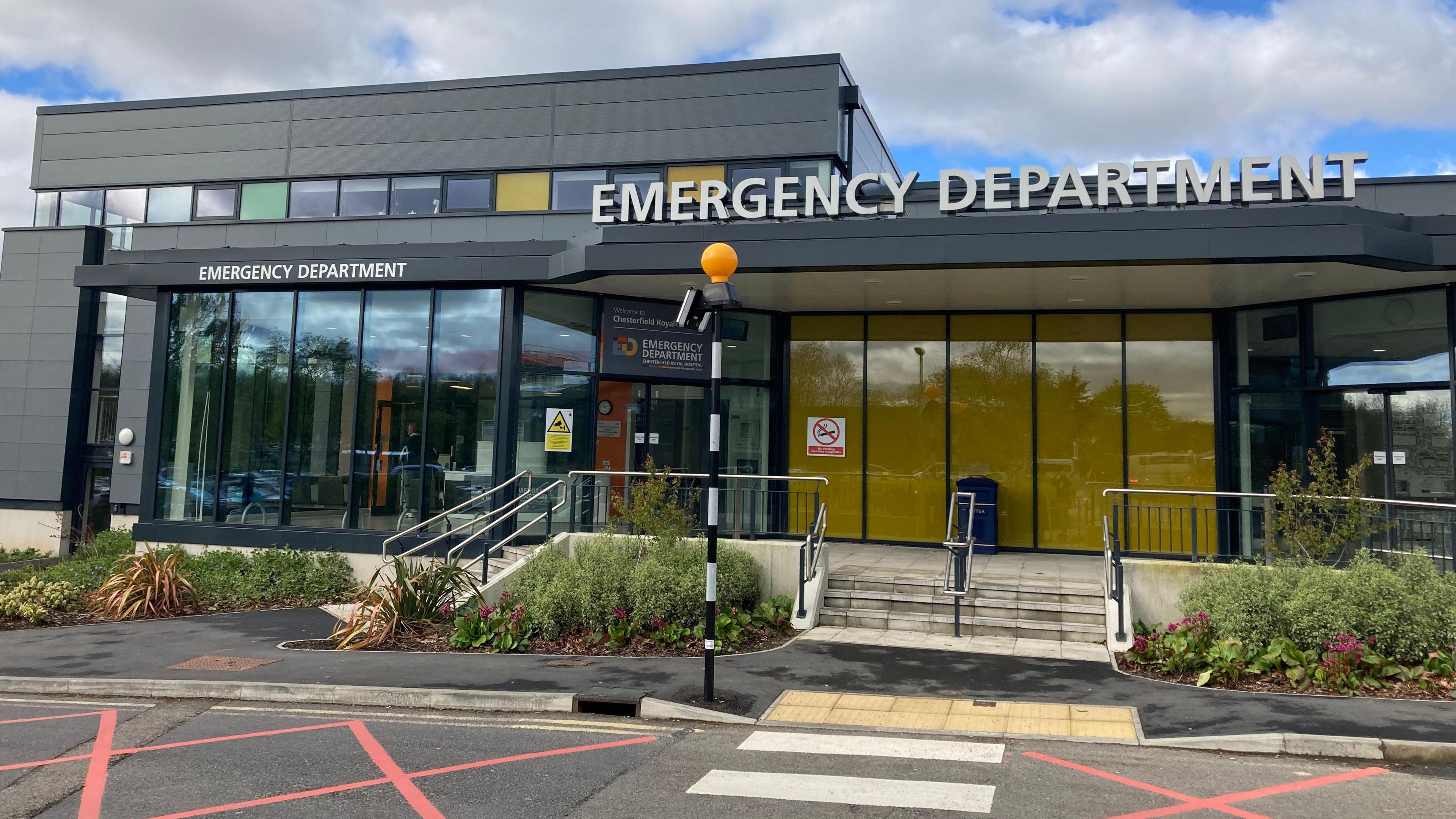 The emergency department at Chesterfield Royal Hospital is pictured. It has large windows and grey cladding, with a sign reading Emergency Department