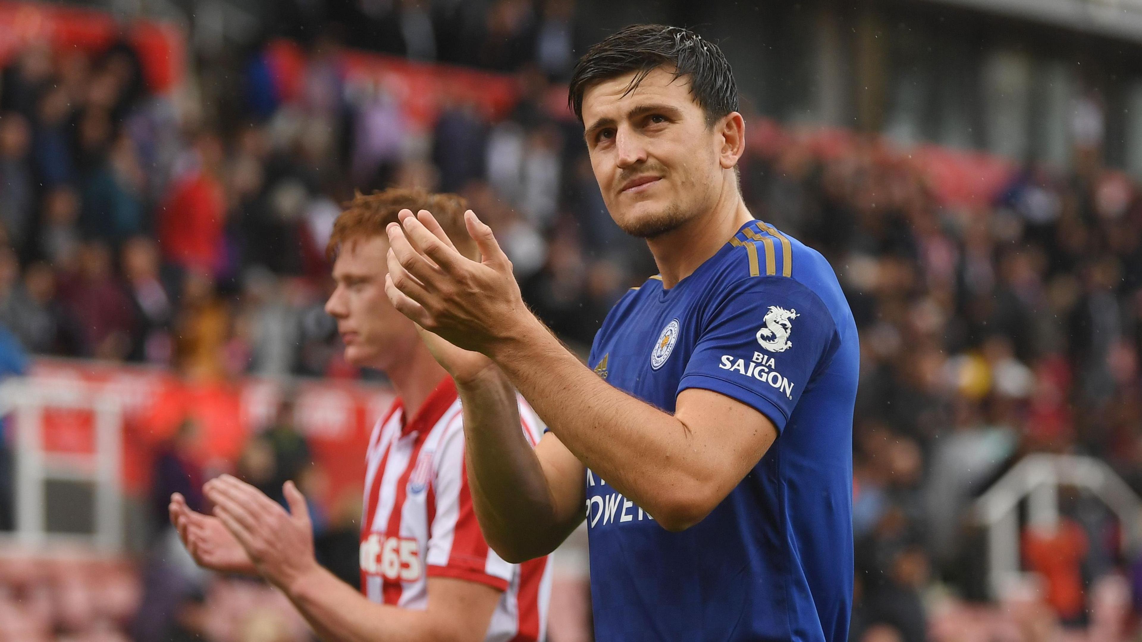 Harry Maguire applauds the fans while playing for Leicester