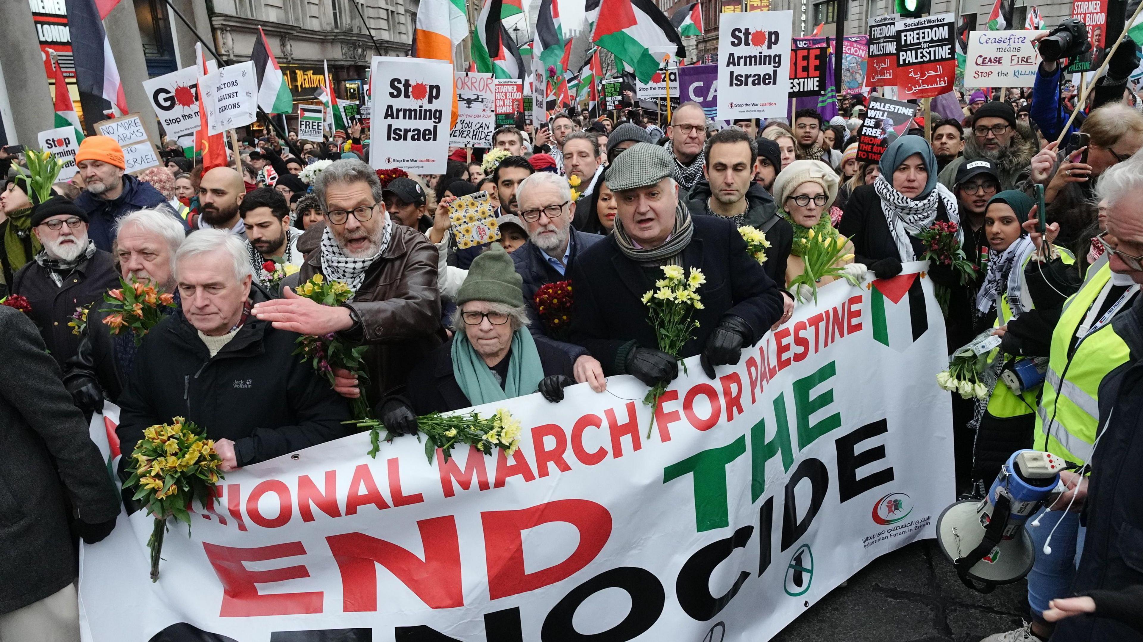 Protestors, including Jeremy Corbyn and John McDonnell, march through London