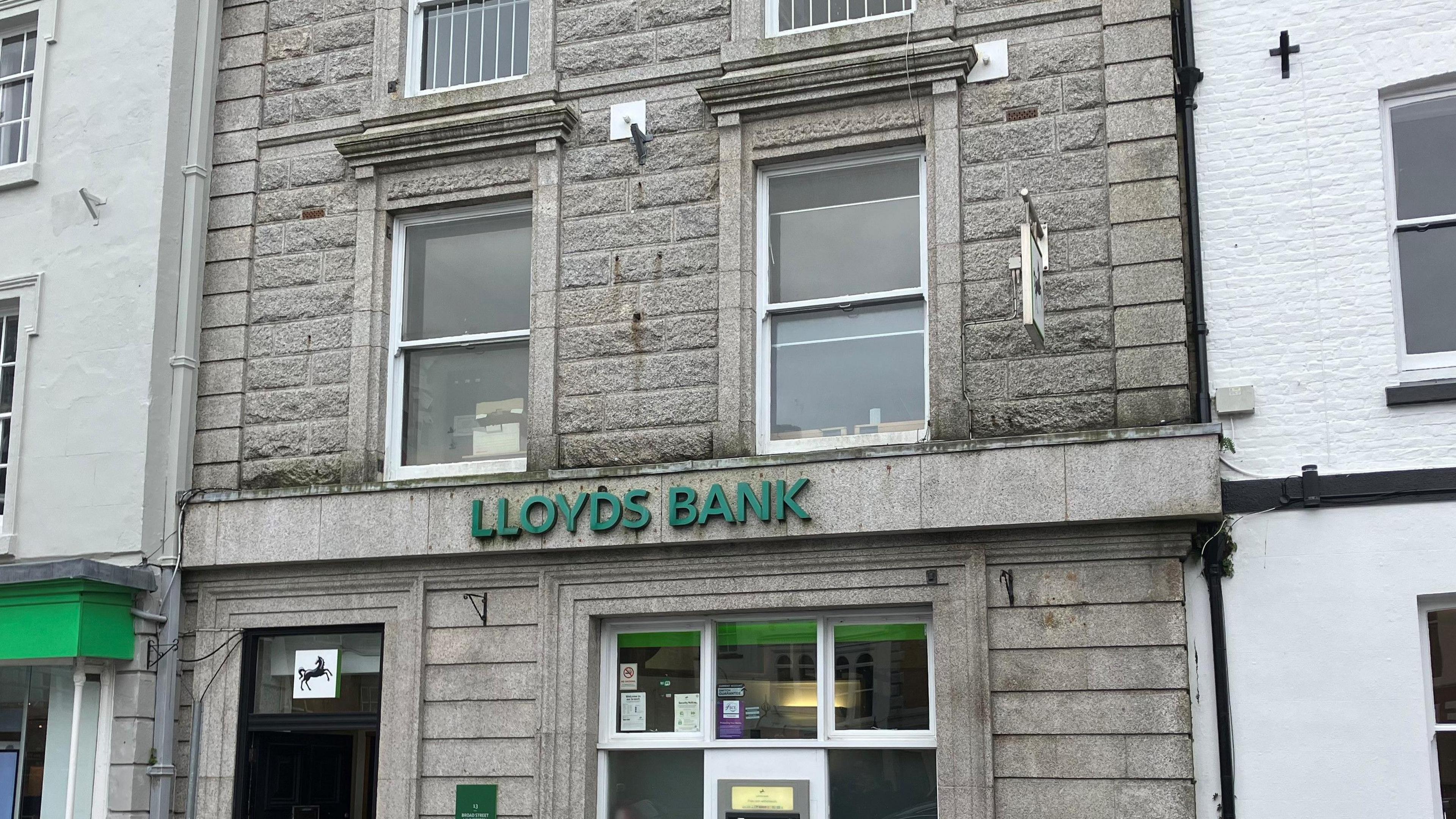 Front of a block building with the words Lloyds Bank on it 