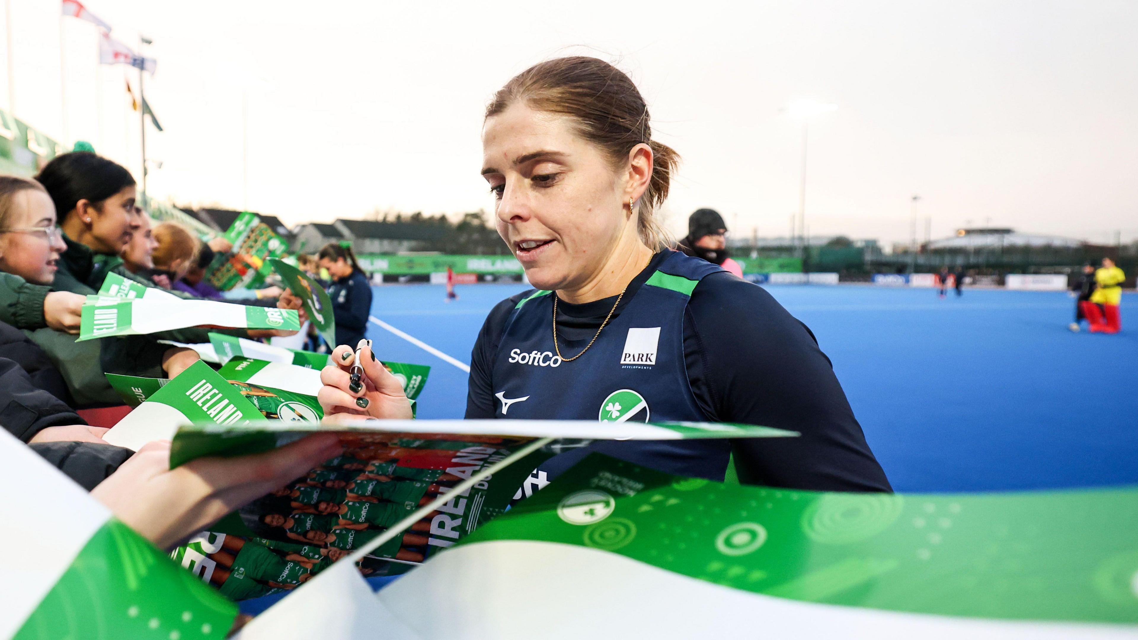 Katie Mullan signing autographs after her 250th appearance for Ireland