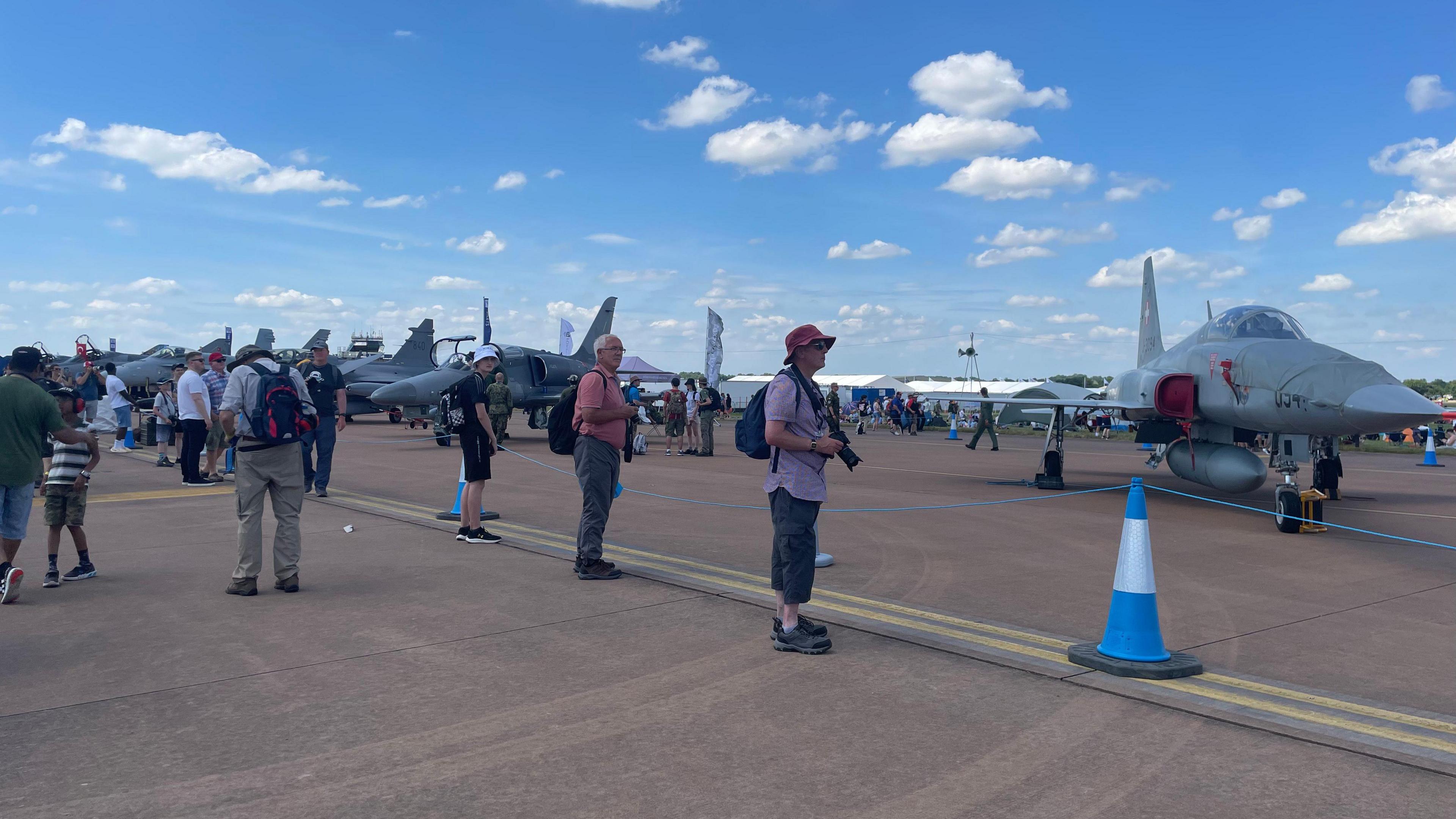 People with cameras looking at planes on the tarmac at RIAT