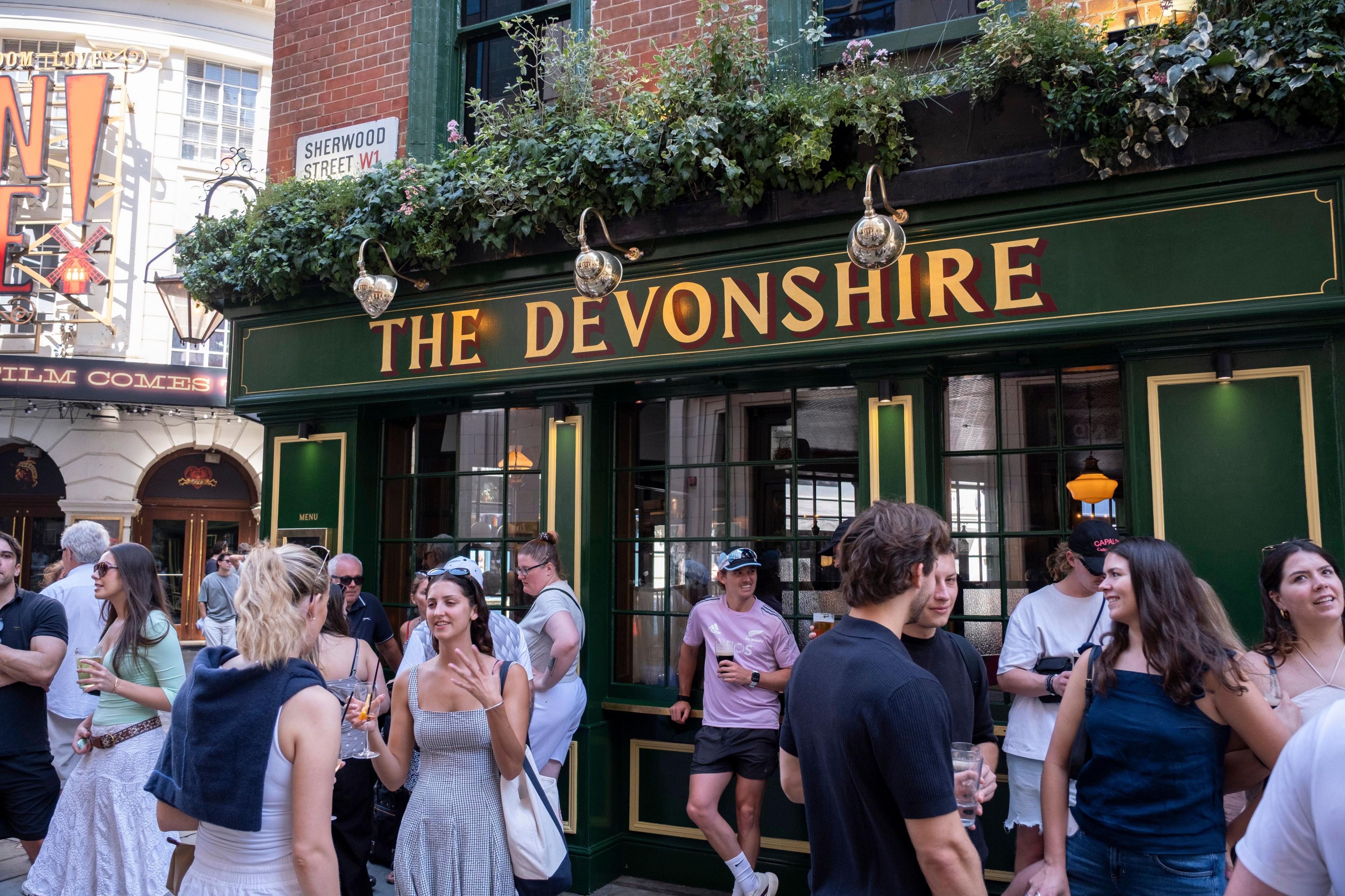 People standing and drinking outside The Devonshire pub
