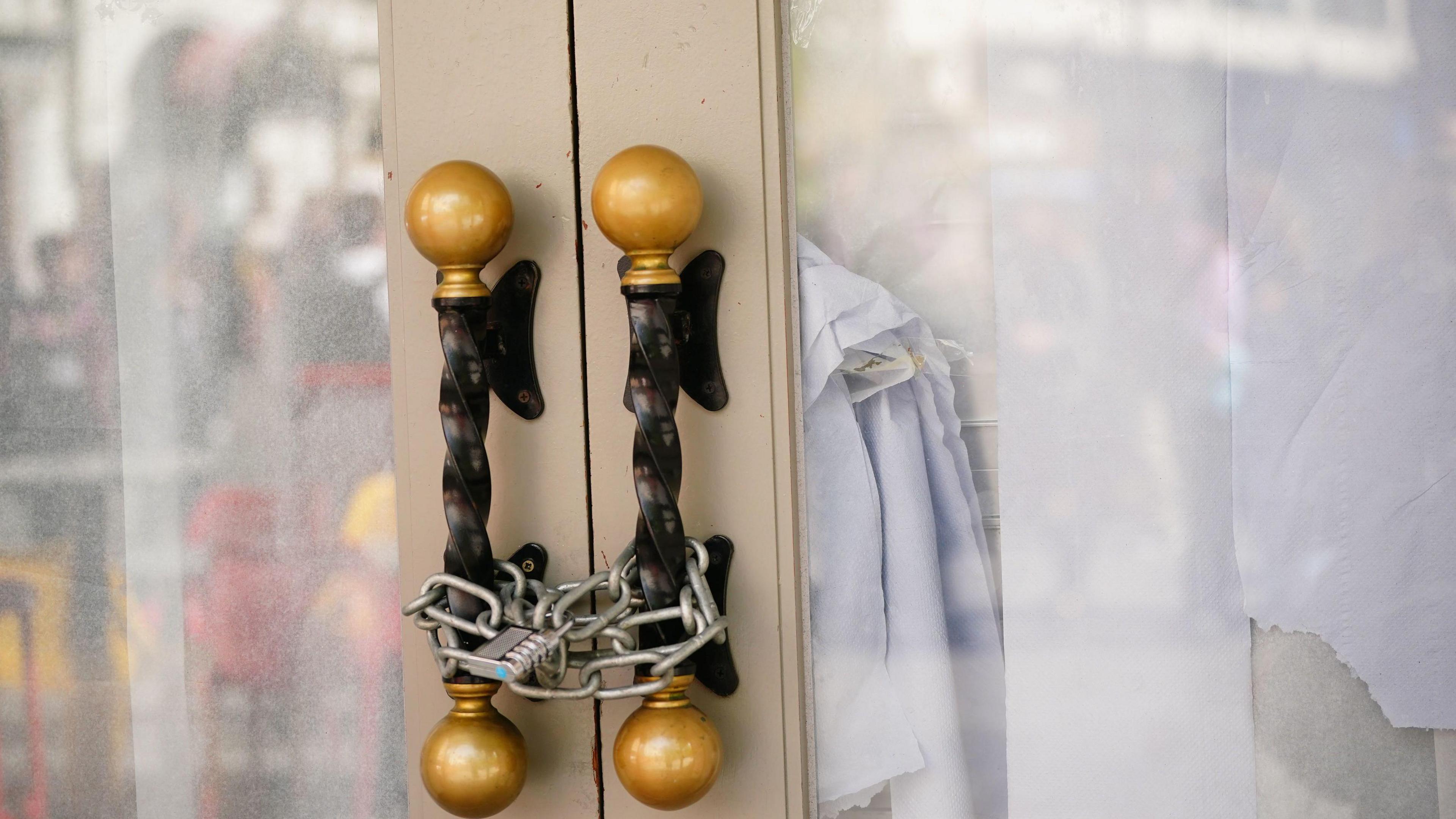 Padlocks on door of former restaurant