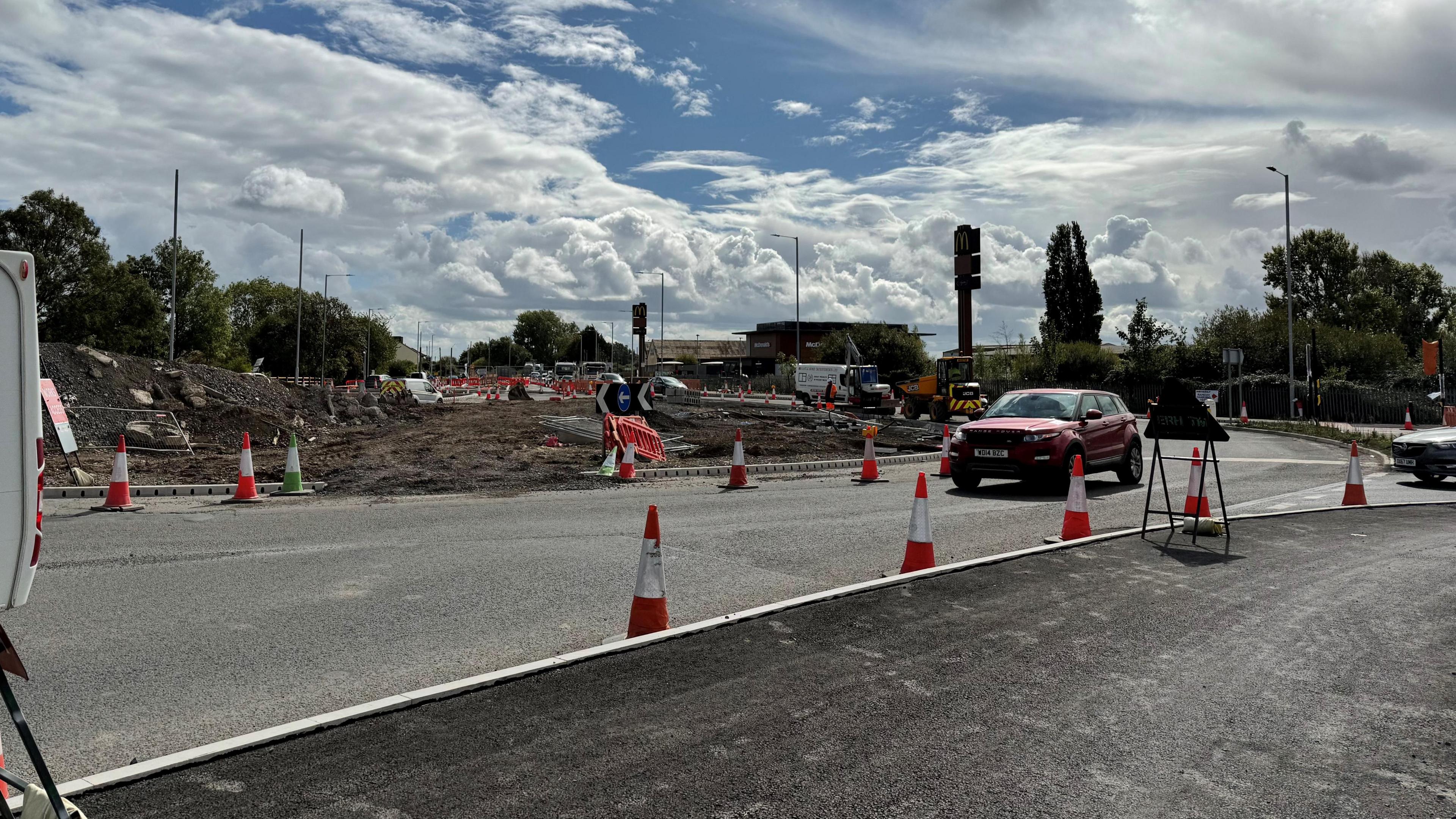 Concrete and cones. There is a roundabout in the middle completely dug up with rubble.