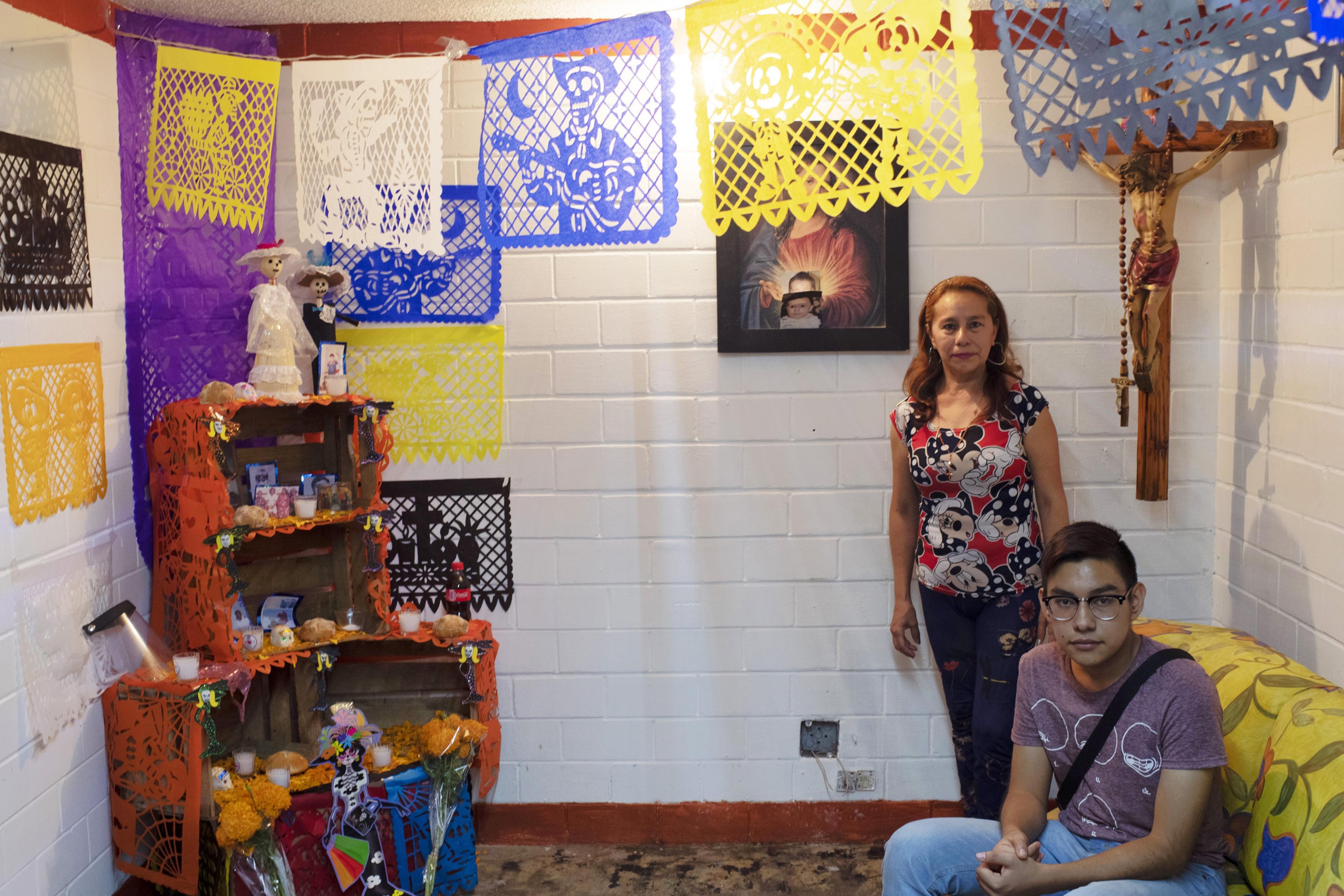 Mayela Alejandra Vela, poses with her 15-year-old son Kevin at the offering at their home, in the Tepito neighbourhood