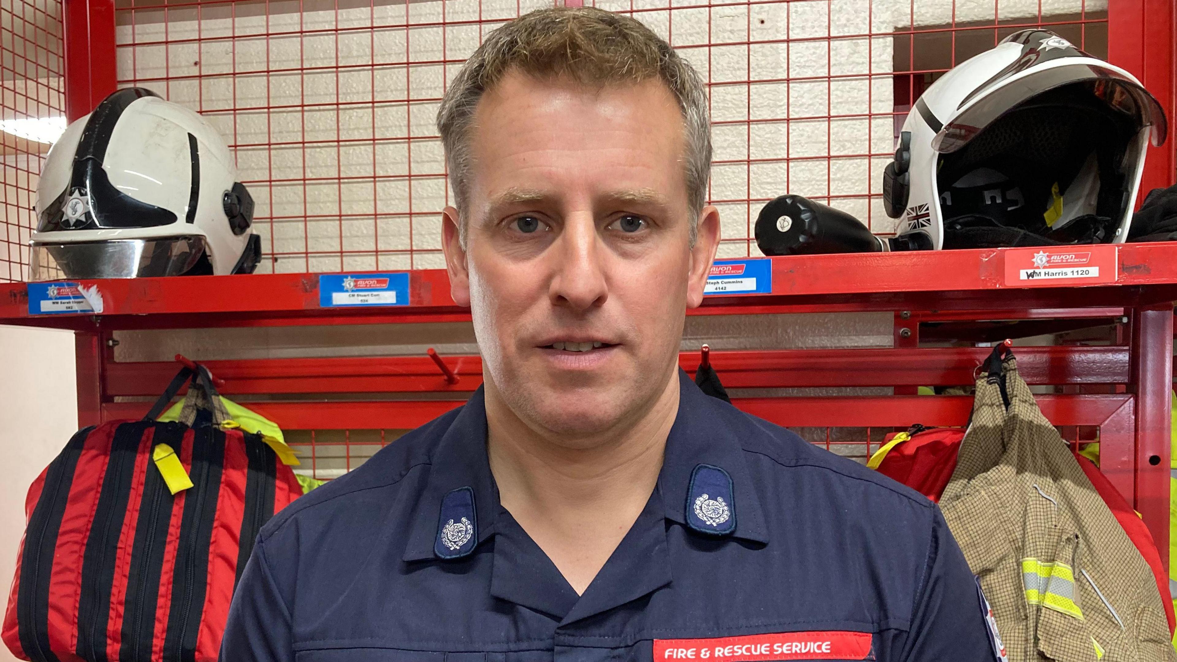 A male firefighter looking into the camera