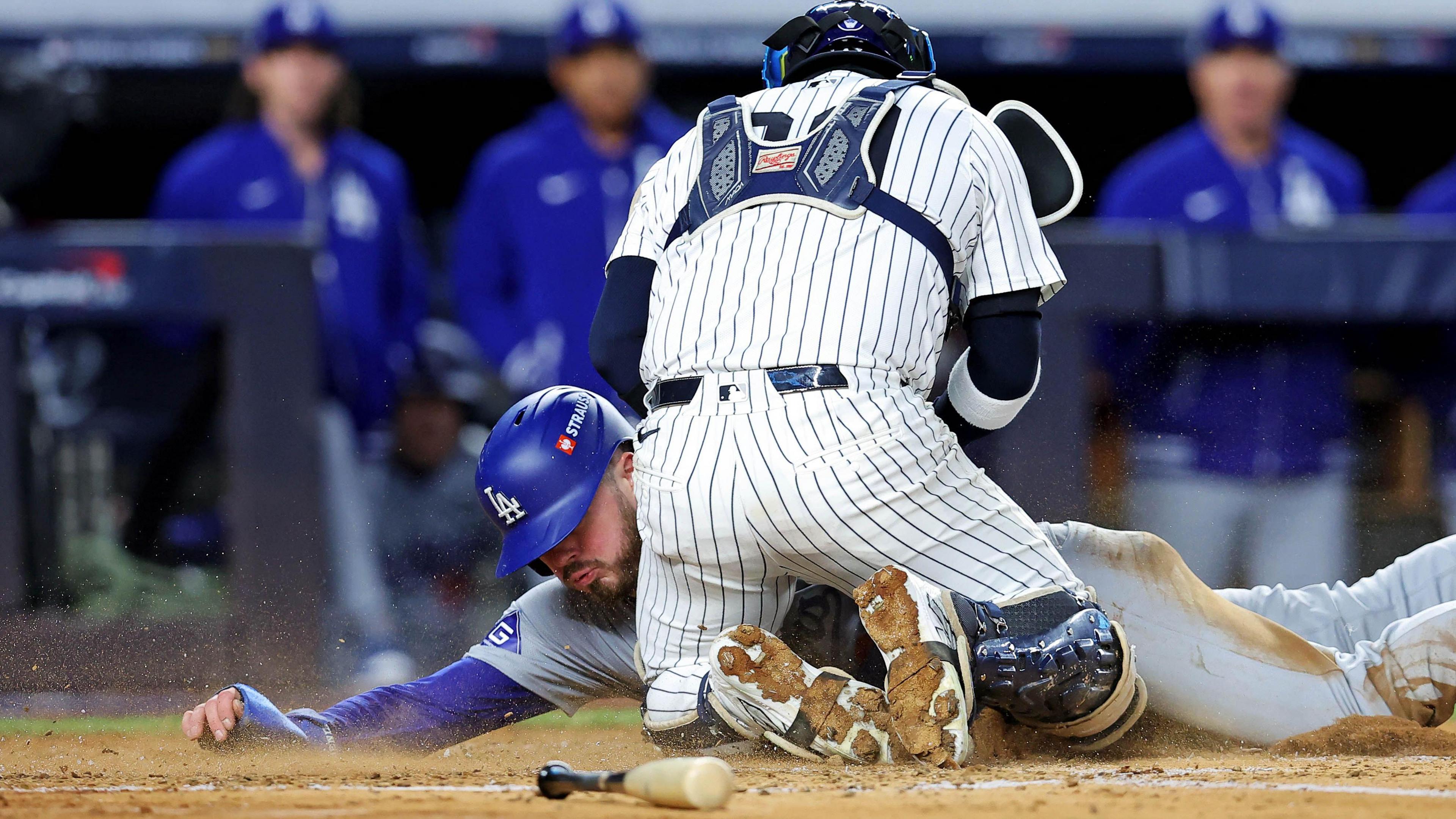 New York Yankees catcher Jose Trevino tags out Los Angeles Dodgers second baseman Gavin Lux as he slides towards home plate