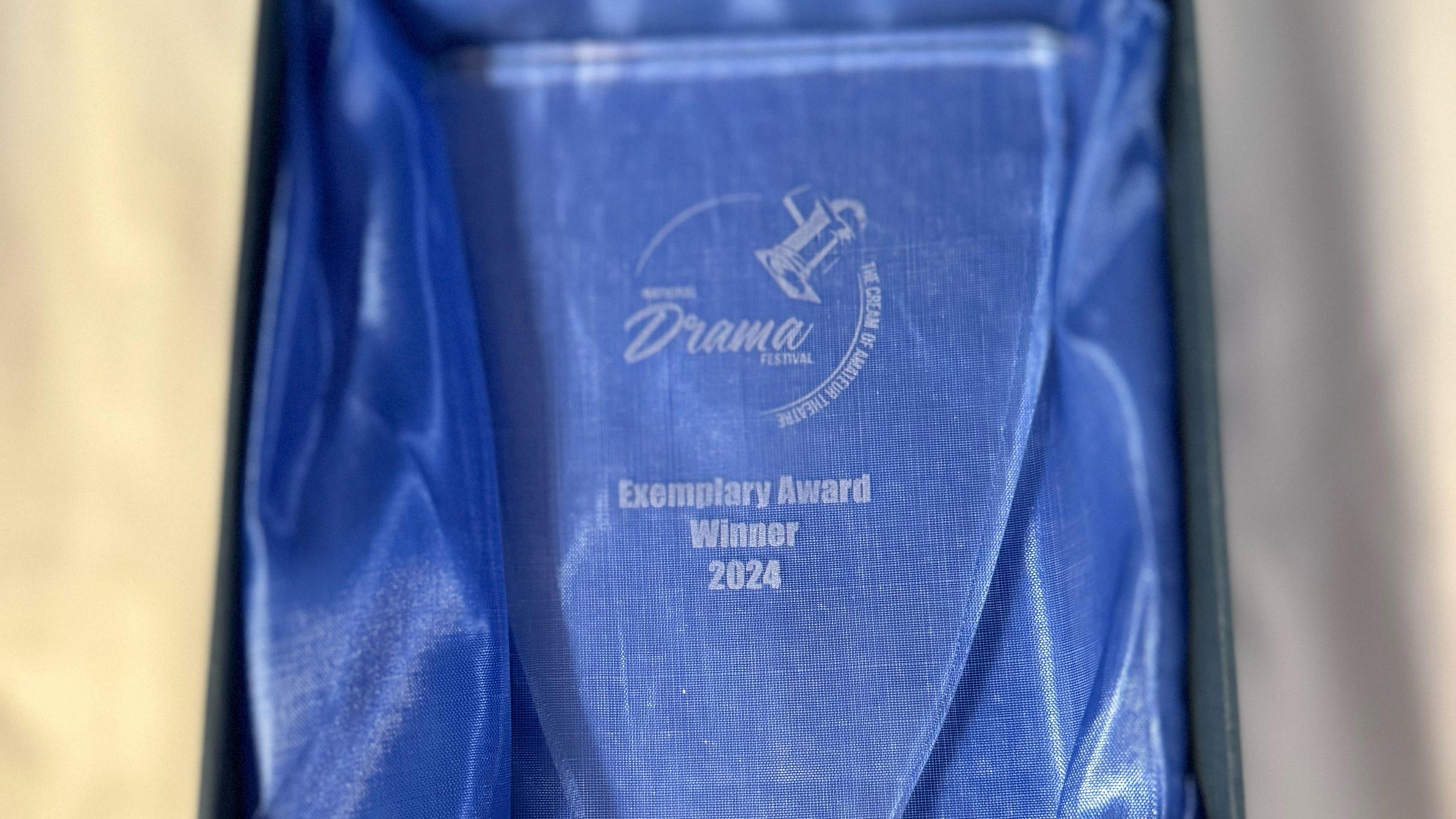 The award in its blue case