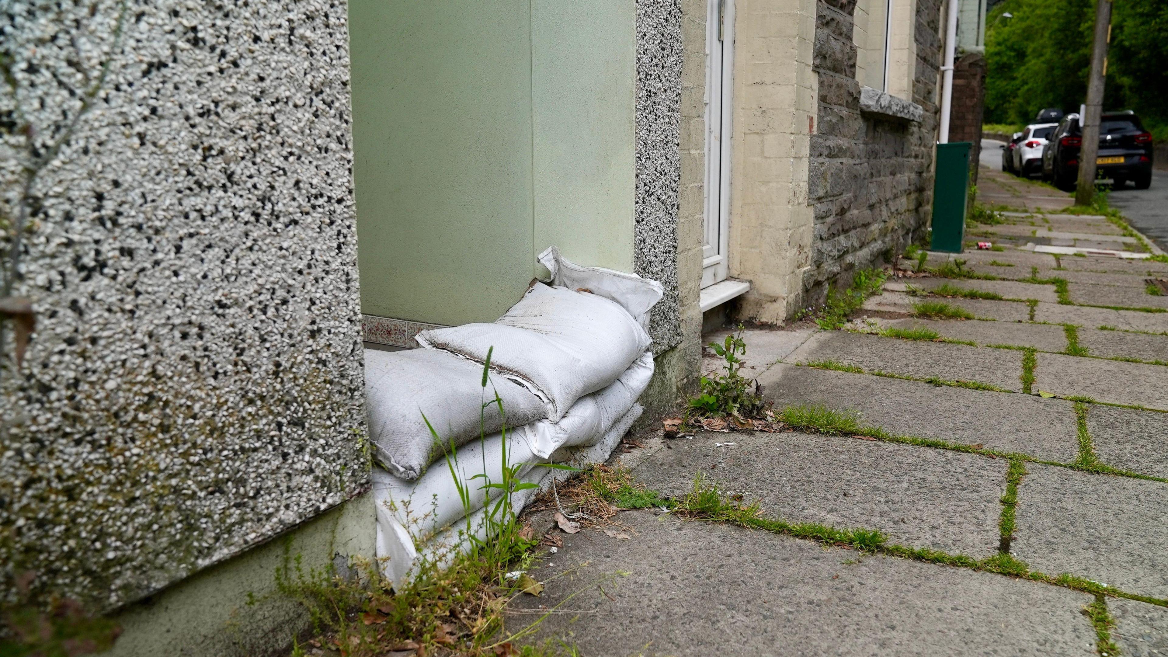 A picture showing sandbags in the doorway of one resident on Clydach Terrace.