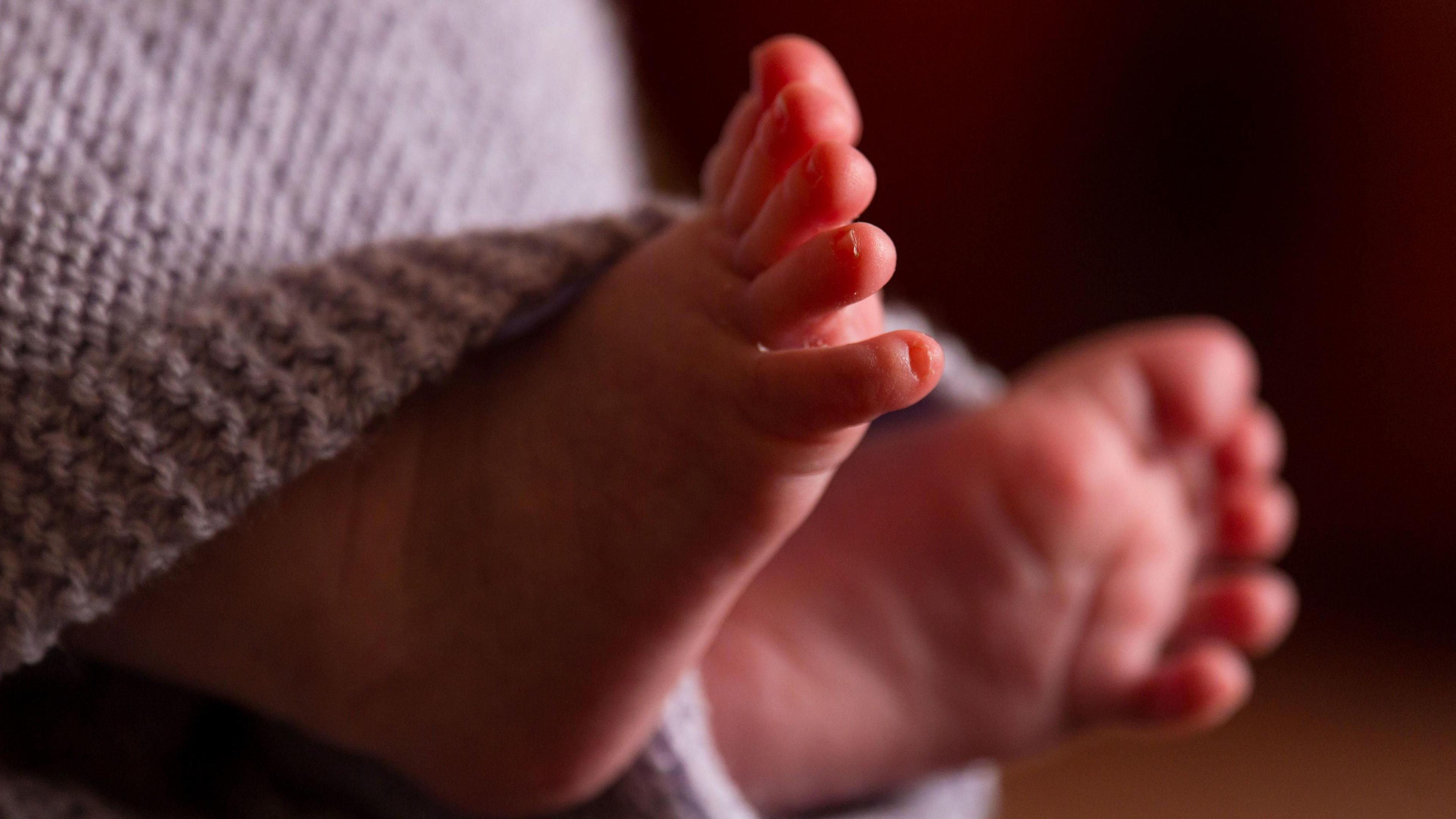 Baby's feet poking out from a blanket