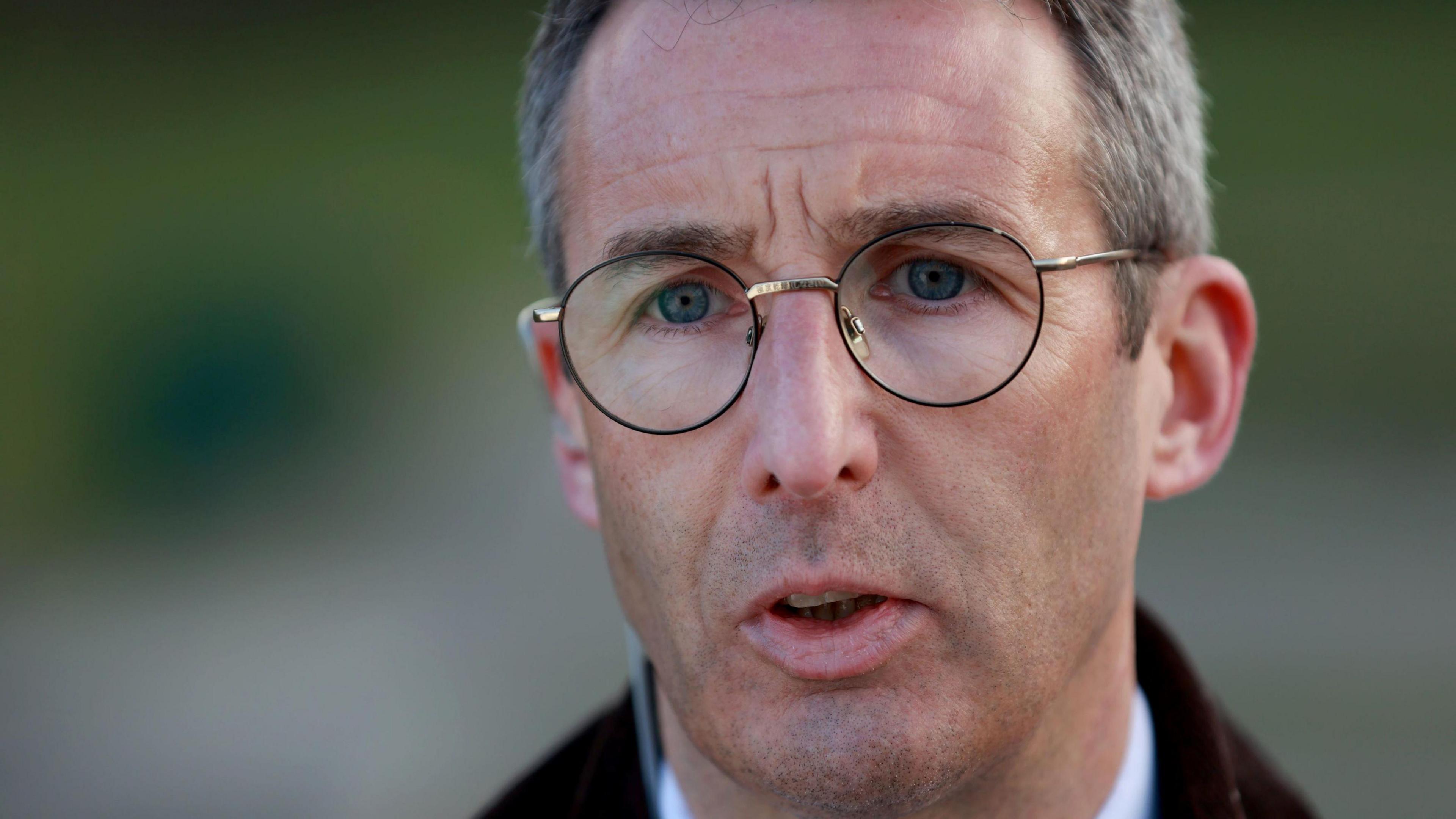A close-up of Andrew Muir speaking. He has grey hair and is wearing a pair of thin wire glasses.