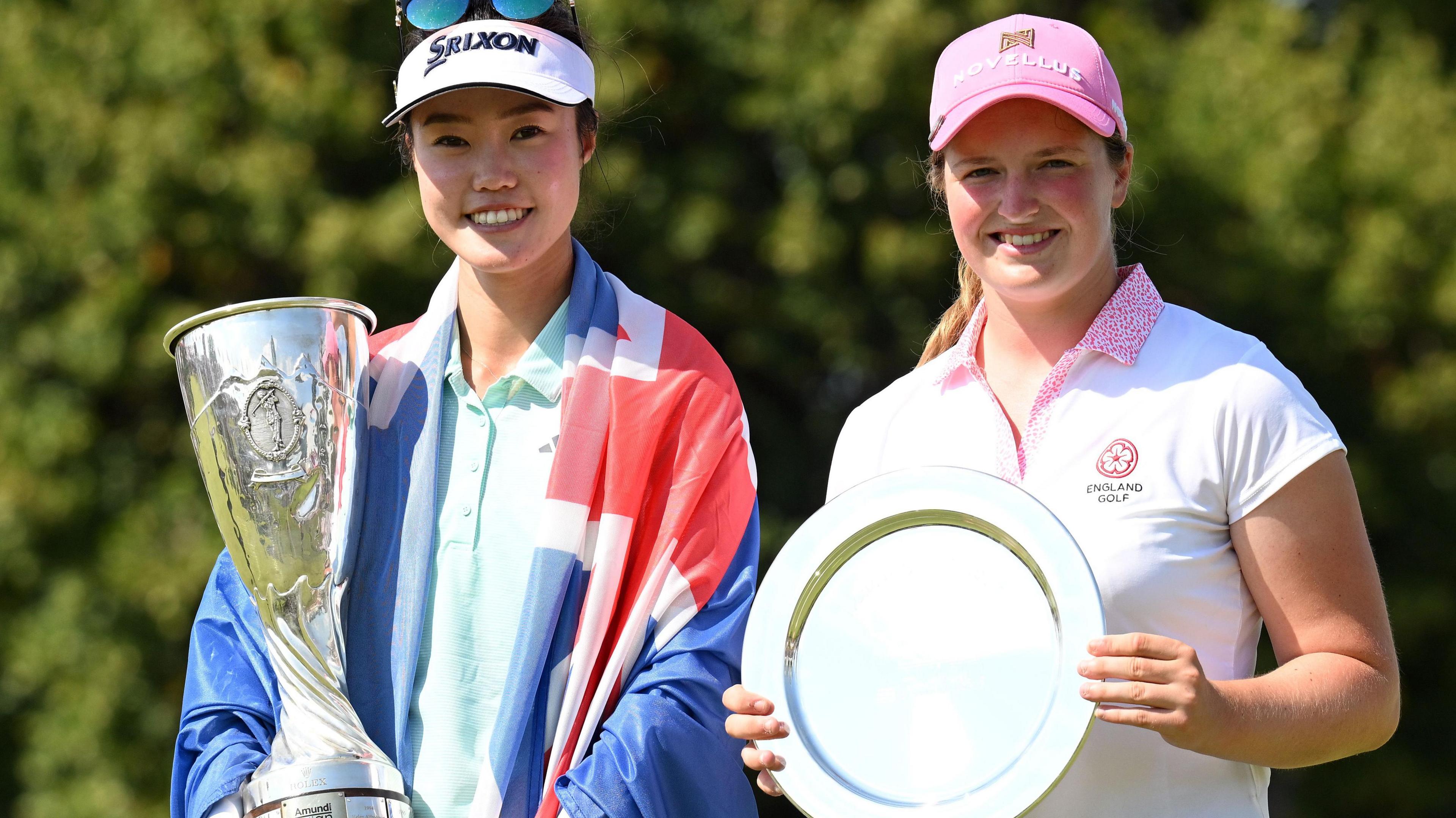 Grace Kim of Australia and England's Lottie Woad hold their trophies after the former won the Evian Championship and the latter finished as the best amateur player at the women's major