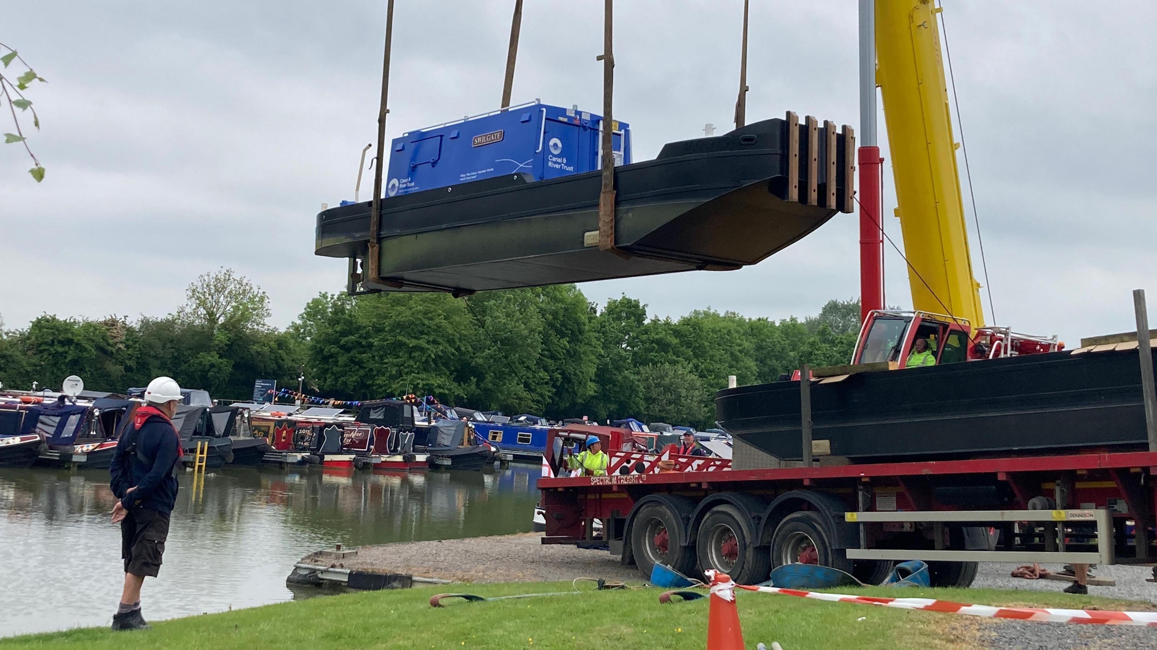 Crane lifting a boat into place at Crick Marina