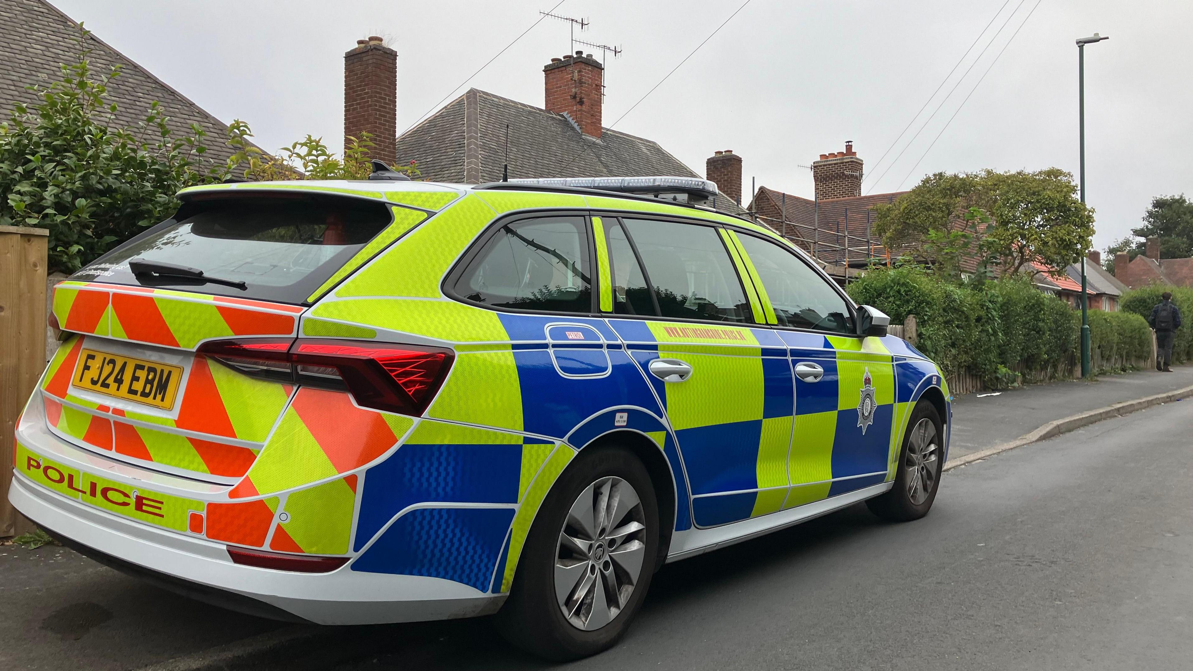 Photograph of a police car parked in Costock Avenue