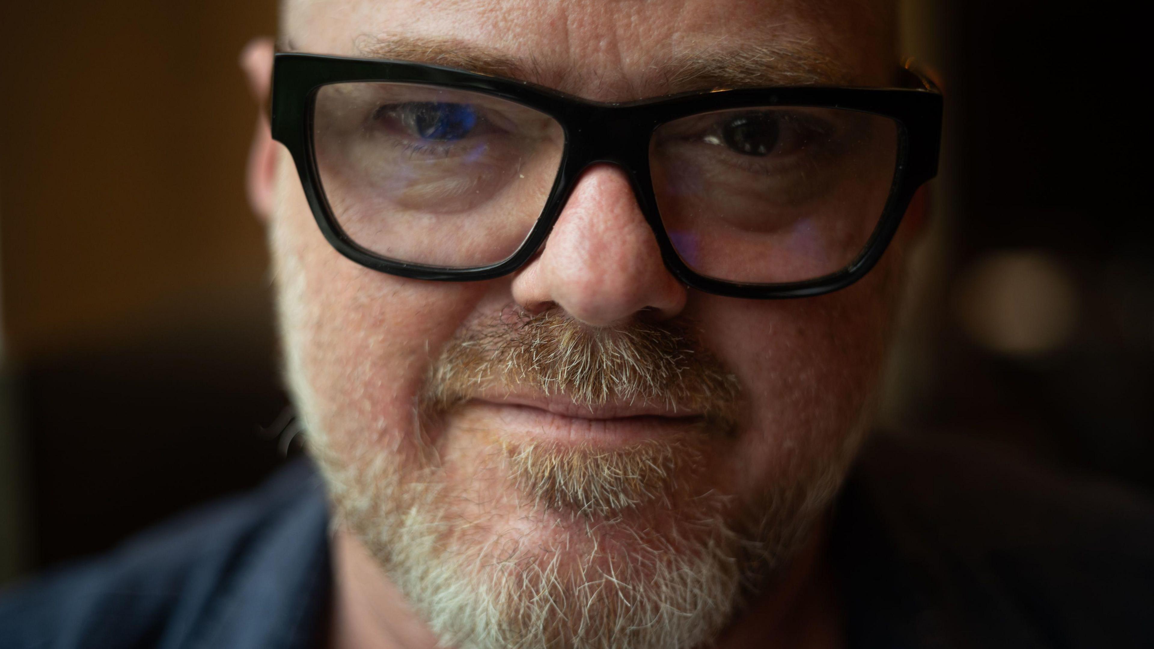 A close-up picture of Heston Blumenthal, who is wearing thick dark-rimmed glasses and has a white beard. 