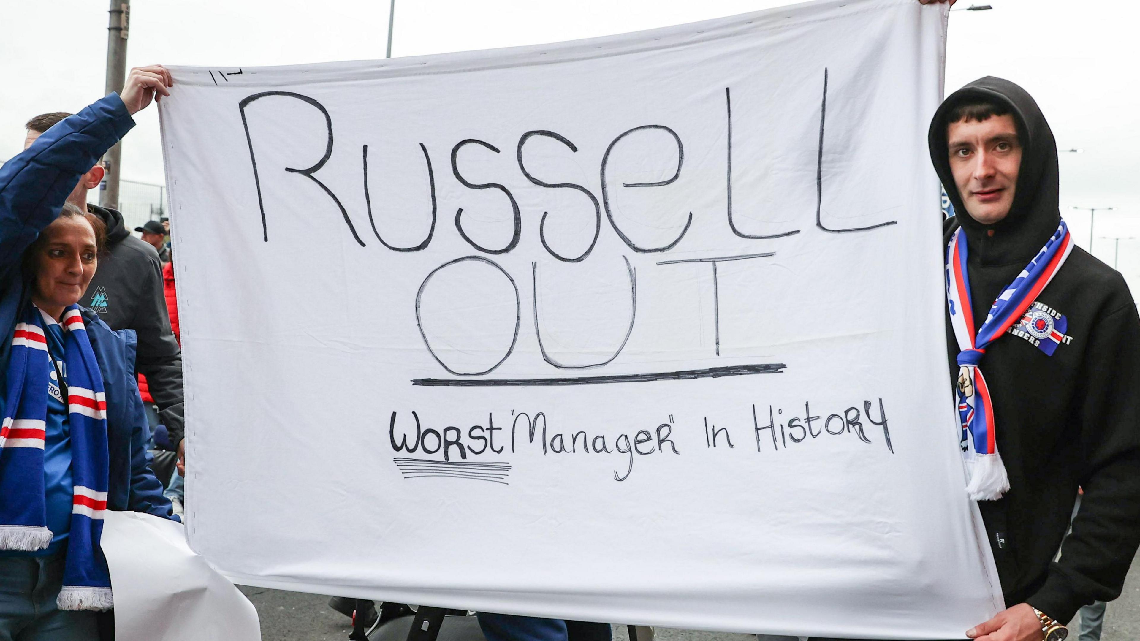 Rangers fans holding a 'Russell Out' banner