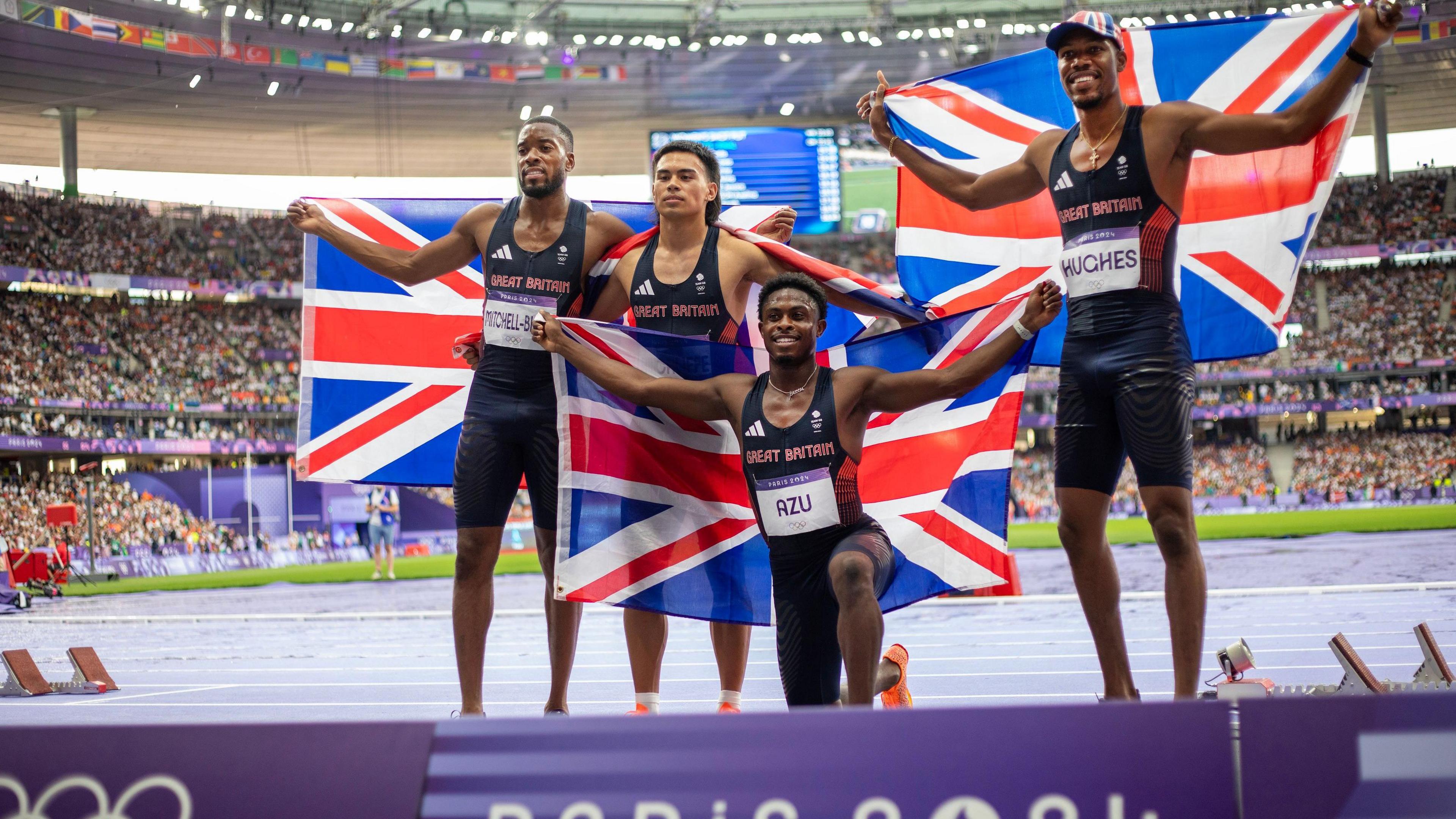 The Great Britain Men's 4x 100m Relay bronze medal-winning team of Nethaneel Mitchell-Blake, Louie Hinchliffe, Jeremiah Azu and Zharnel Hughes celebrate during the Paris 2024 Summer Olympic Games on August 9, 2024 in Paris