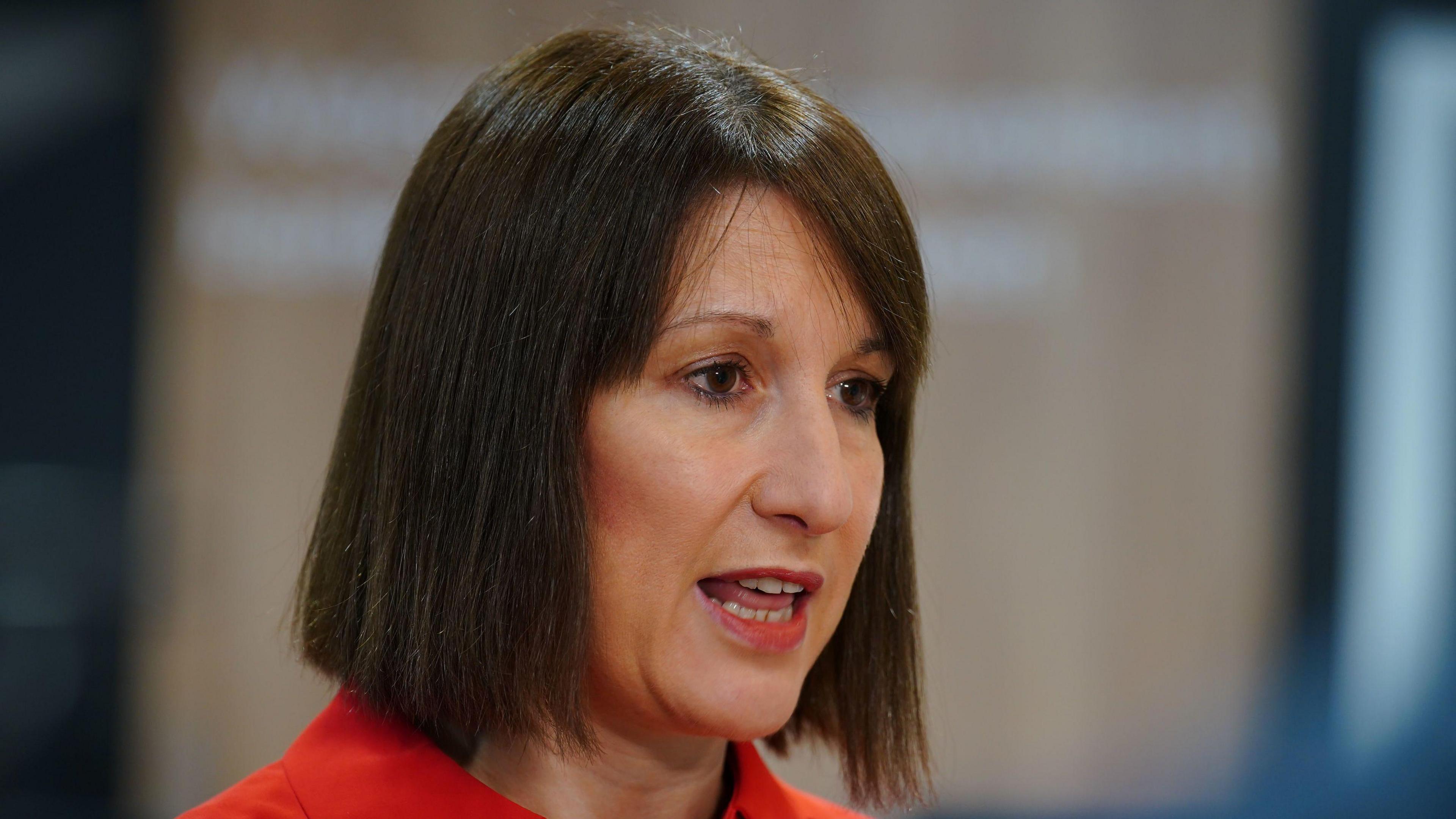 Rachel Reeves speaking to the media at a banking hub