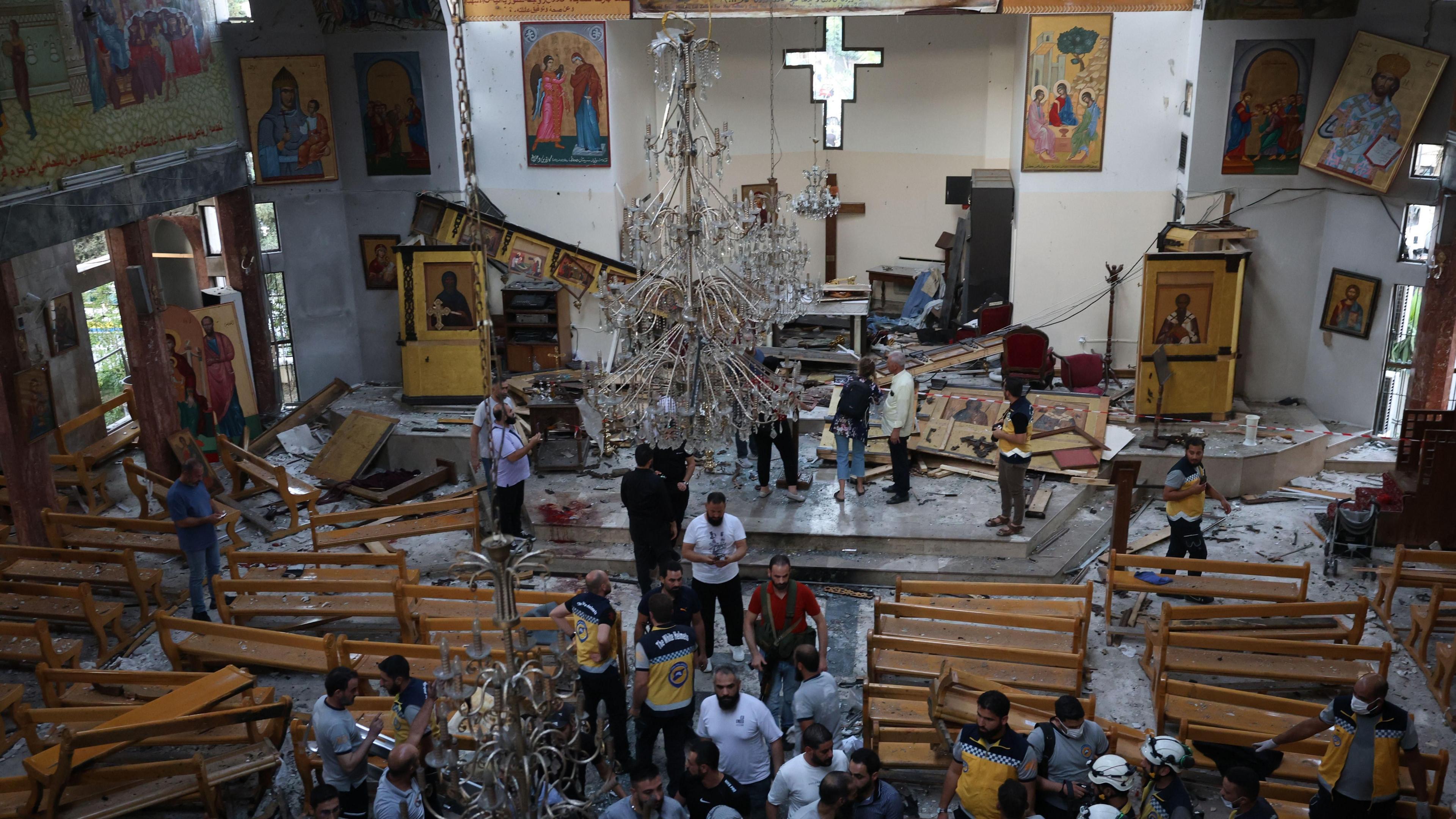People inspect damage following a suicide bomb attack at the Mar Elias Church in Dweila, a suburb of Damascus, Syria (22 June 2025)