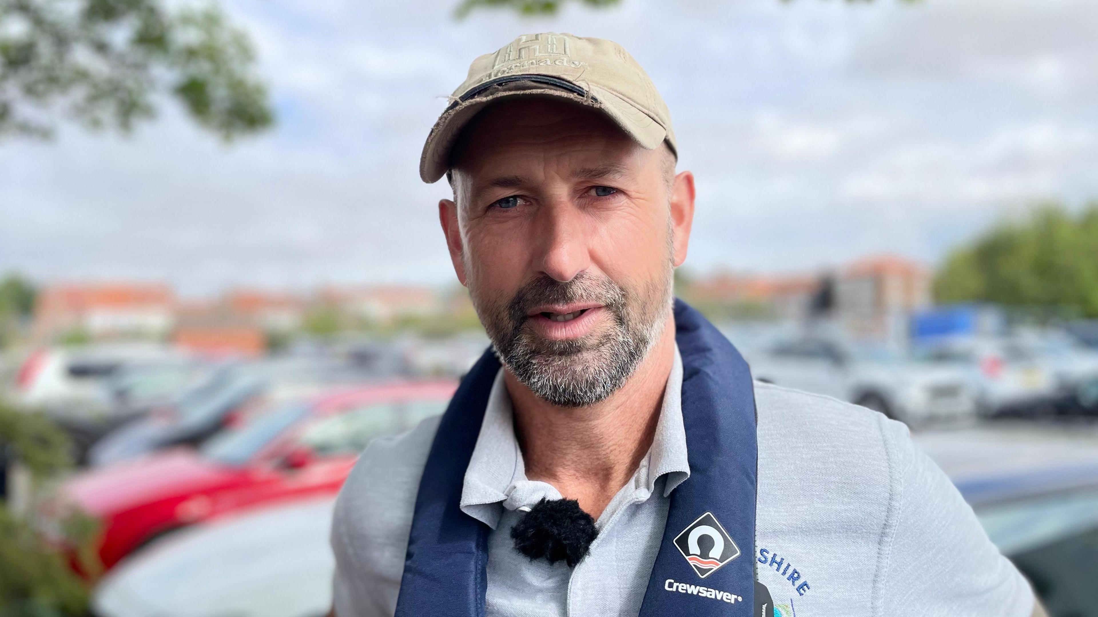 Matt Arnold from East Yorkshire Rivers Trust. He is wearing a grey polo shirt and a beige baseball cap.
