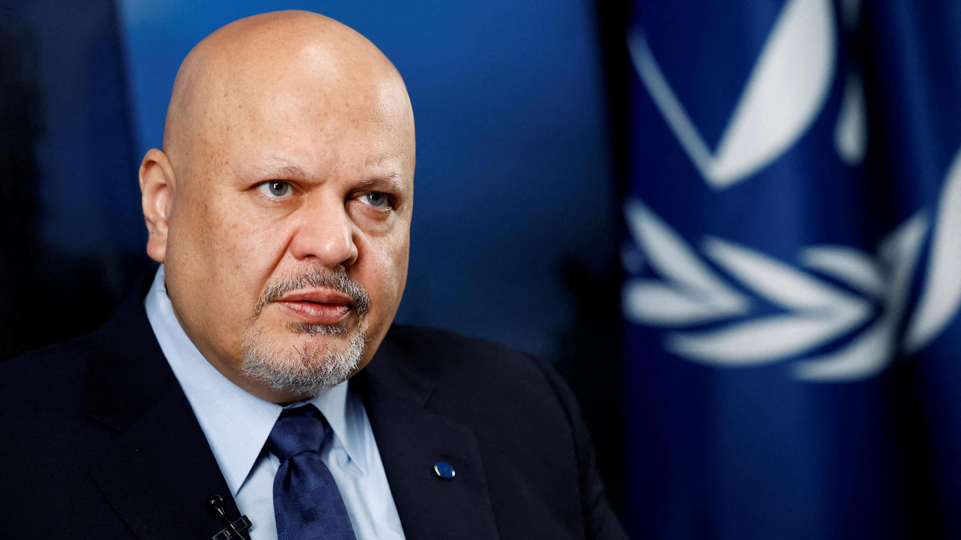 File photo of ICC prosecutor Khan in front of a blue background