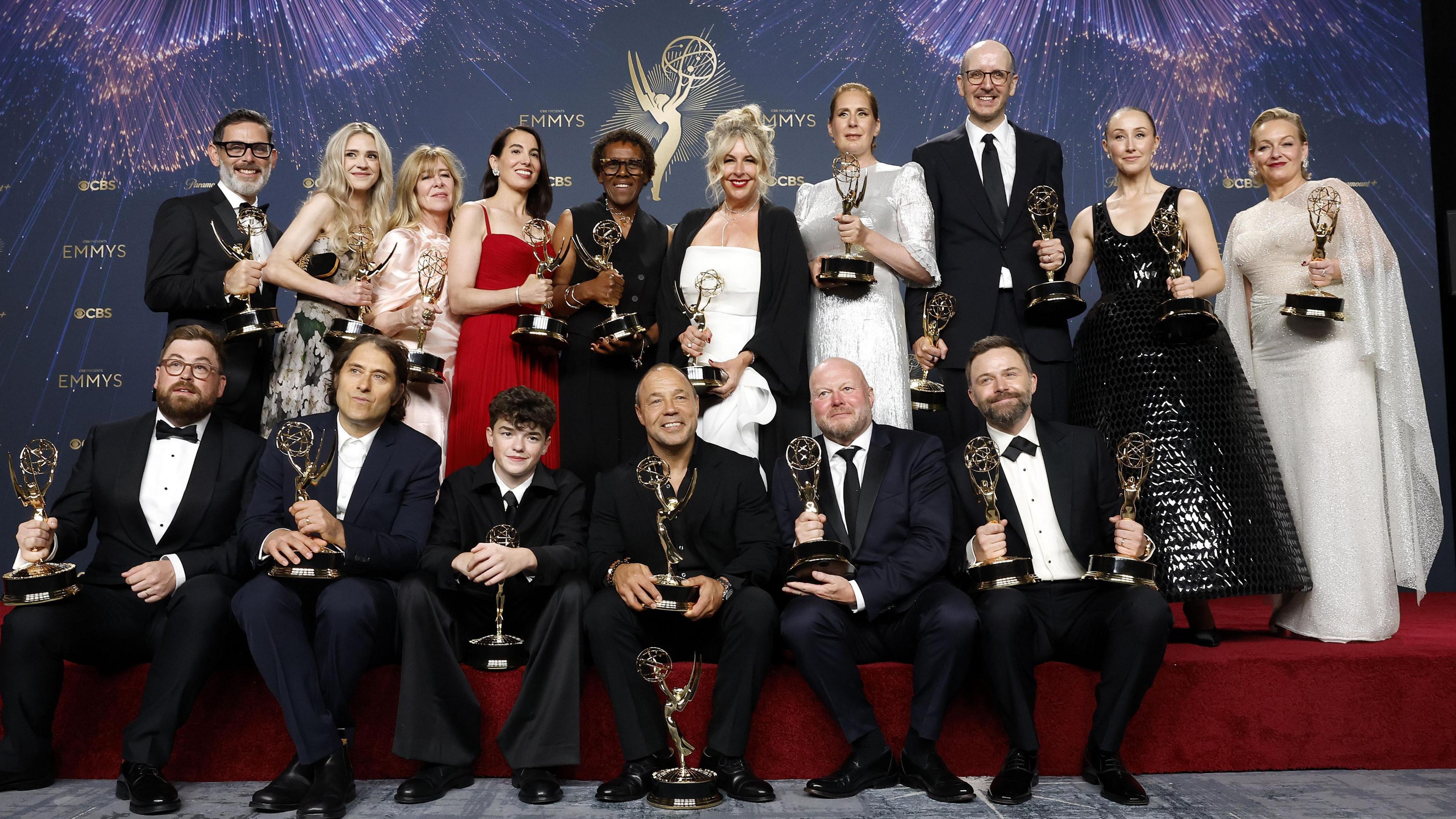 The cast of Adolescence pose for a photograph with their Emmy awards.