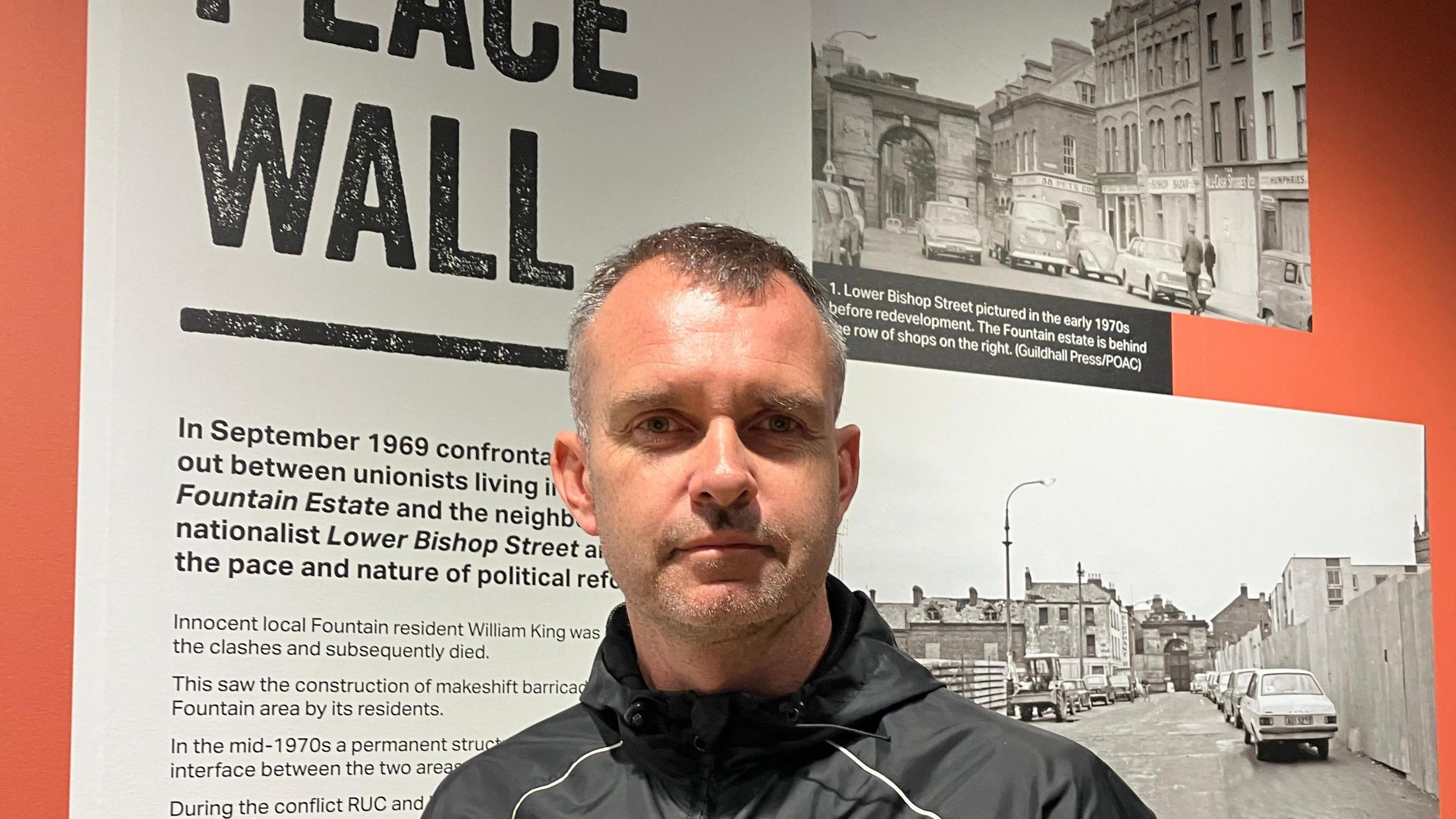 The museum’s project manager, Michael Cooper, standing in front of an exhibit