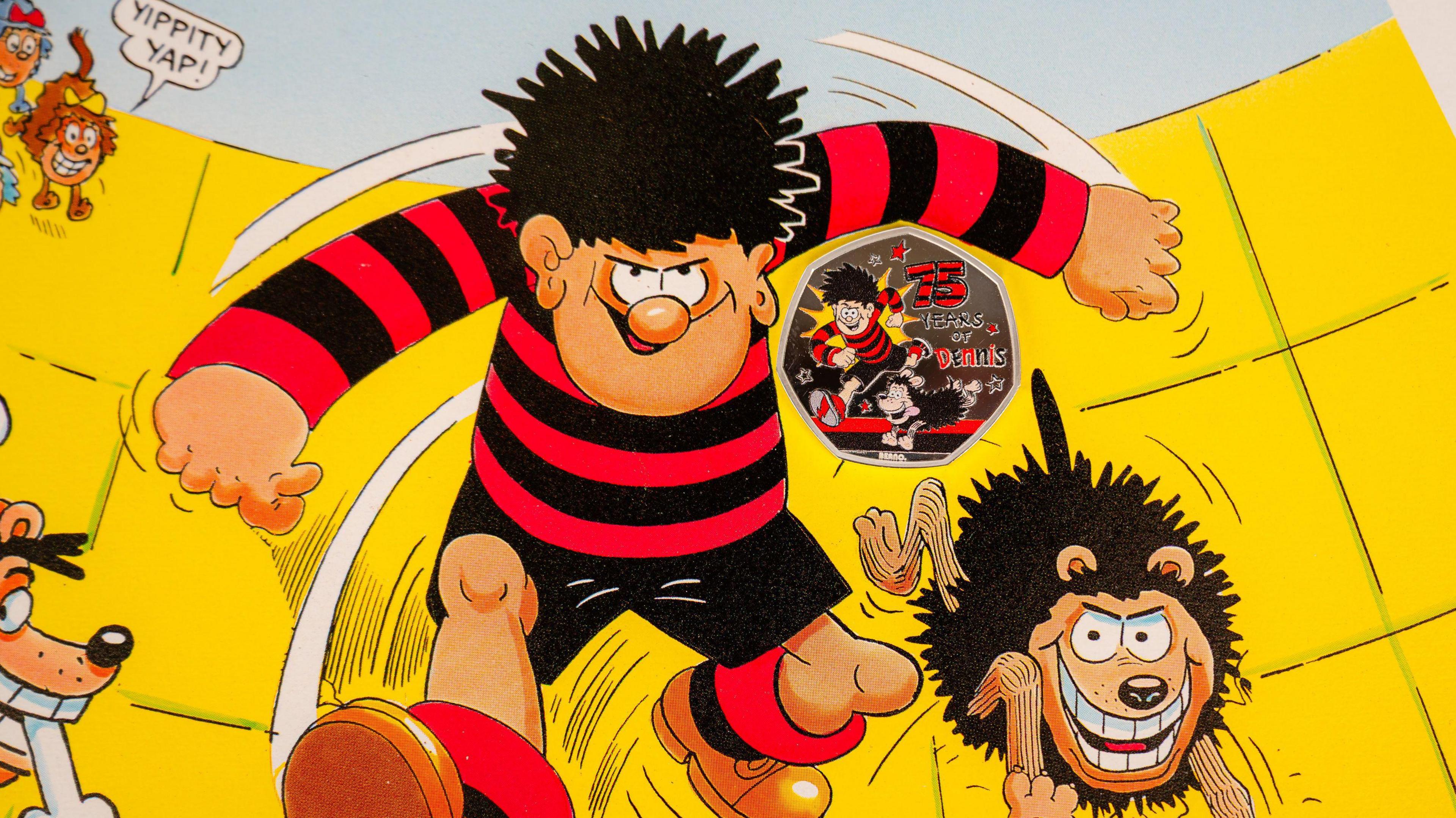 a cartoon of Dennis the menace and Gnasher with a special commemorative coin