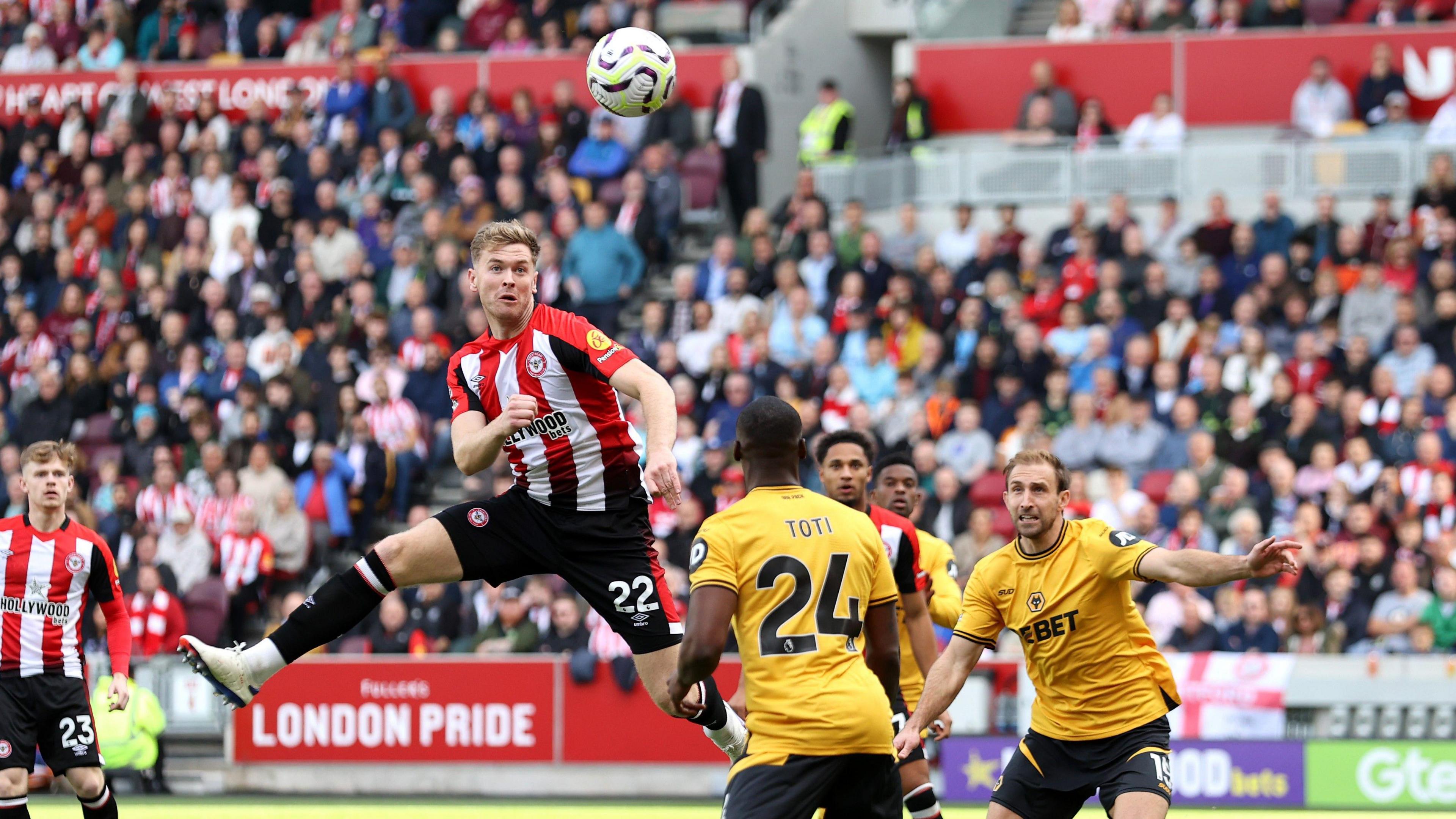 Brentford defender Nathan Collins rises to score in the second minute against his former club Wolves.